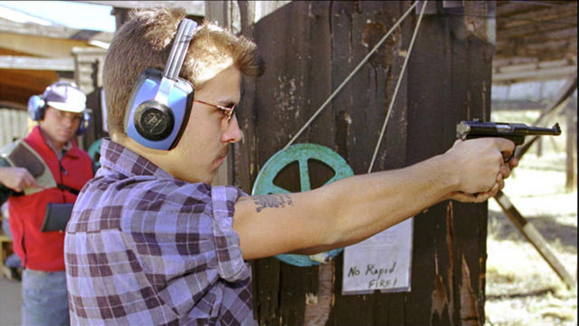 Man performs target practice at a shooting range