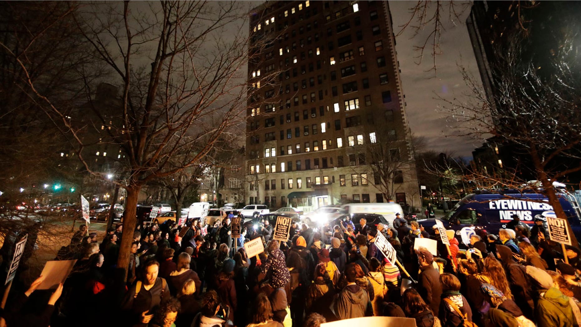Protesters gather across the street from the home of U.S. Sen. Chuck Schumer, D-N.Y., in Brooklyn, N.Y.