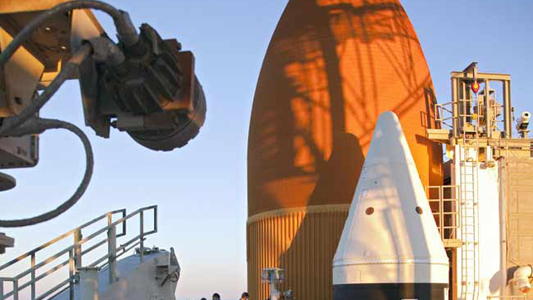 On Launch Pad 39A at NASA's Kennedy Space Center in Florida, workers removed the vent line attached to the ground umbilical carrier plate on shuttle Discovery's bright-orange external fuel tank. A hydrogen gas leak at that location during tanking for Discovery's STS-133 mission to the International Space Station caused the launch attempt to be scrubbed Nov. 5.