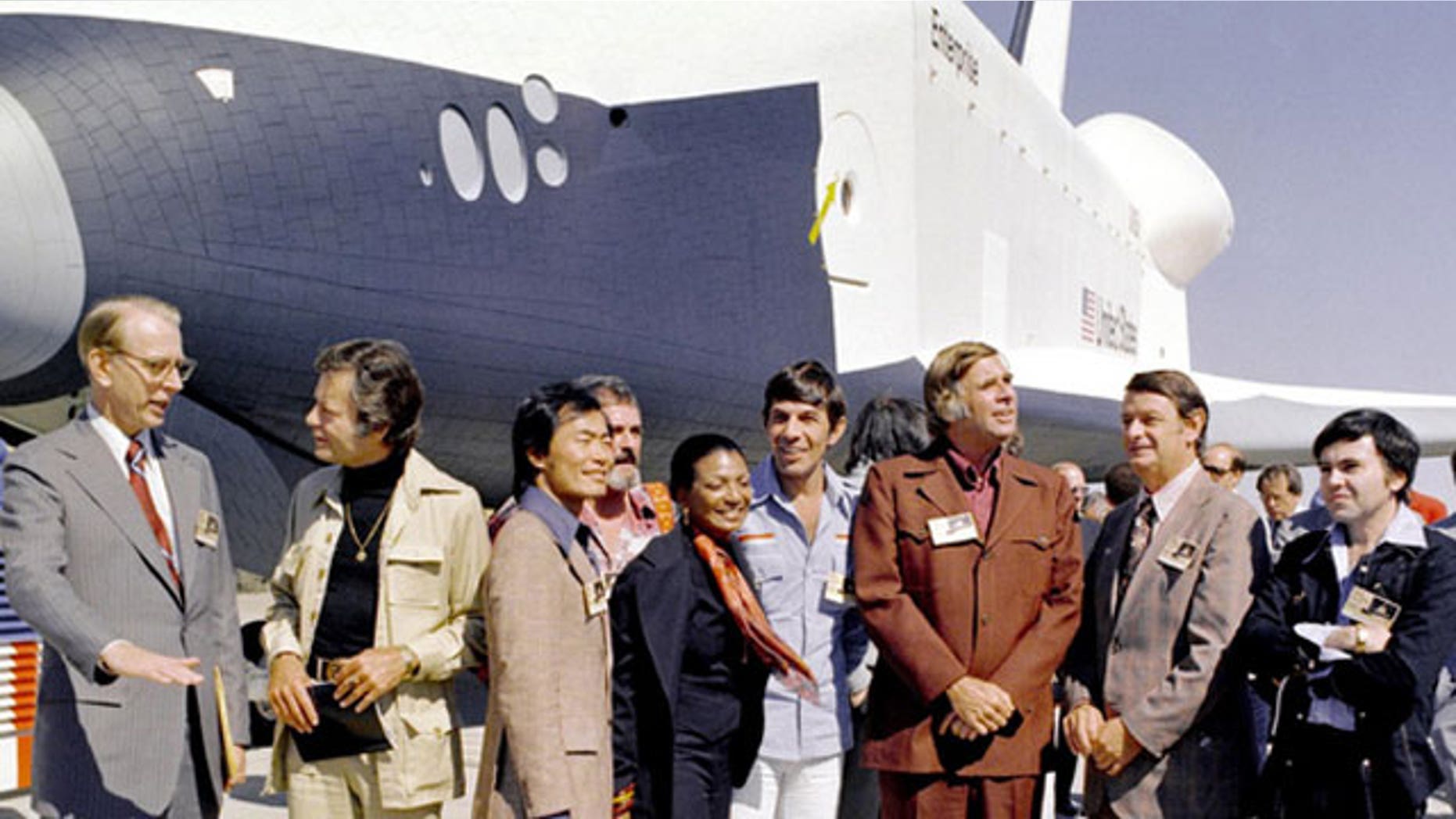 n 1976, NASA's space shuttle Enterprise rolled out of the Palmdale manufacturing facilities and was greeted by NASA officials and cast members from the 'Star Trek' television series. From left to right they are: NASA Administrator Dr. James D. Fletcher; DeForest Kelley, who portrayed Dr. "Bones" McCoy on the series; George Takei (Mr. Sulu); James Doohan (Chief Engineer Montgomery "Scotty" Scott); Nichelle Nichols (Lt. Uhura); Leonard Nimoy (Mr. Spock); series creator Gene Rodenberry; an unnamed NASA official; and, Walter Koenig (Ensign Pavel Chekov).