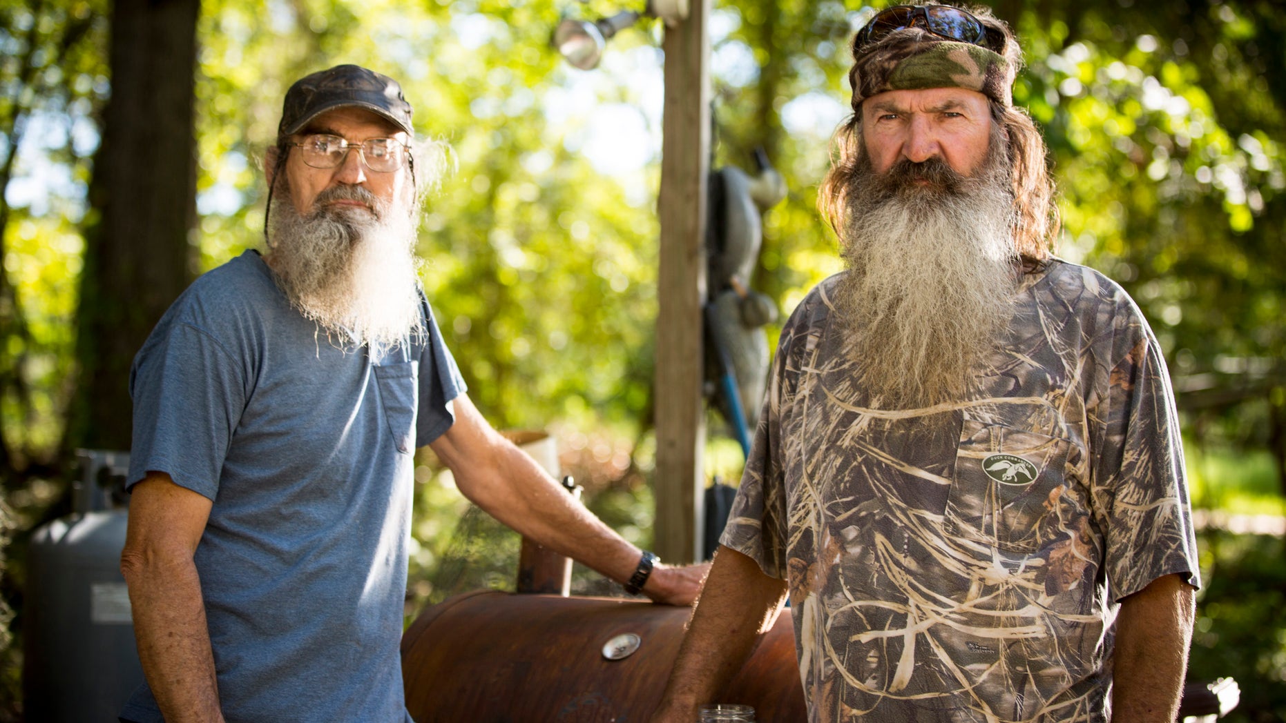 This undated image released by A&E shows brothers Silas "Uncle Si" Robertson, left, and Phil Robertson from the popular series "Duck Dynasty."