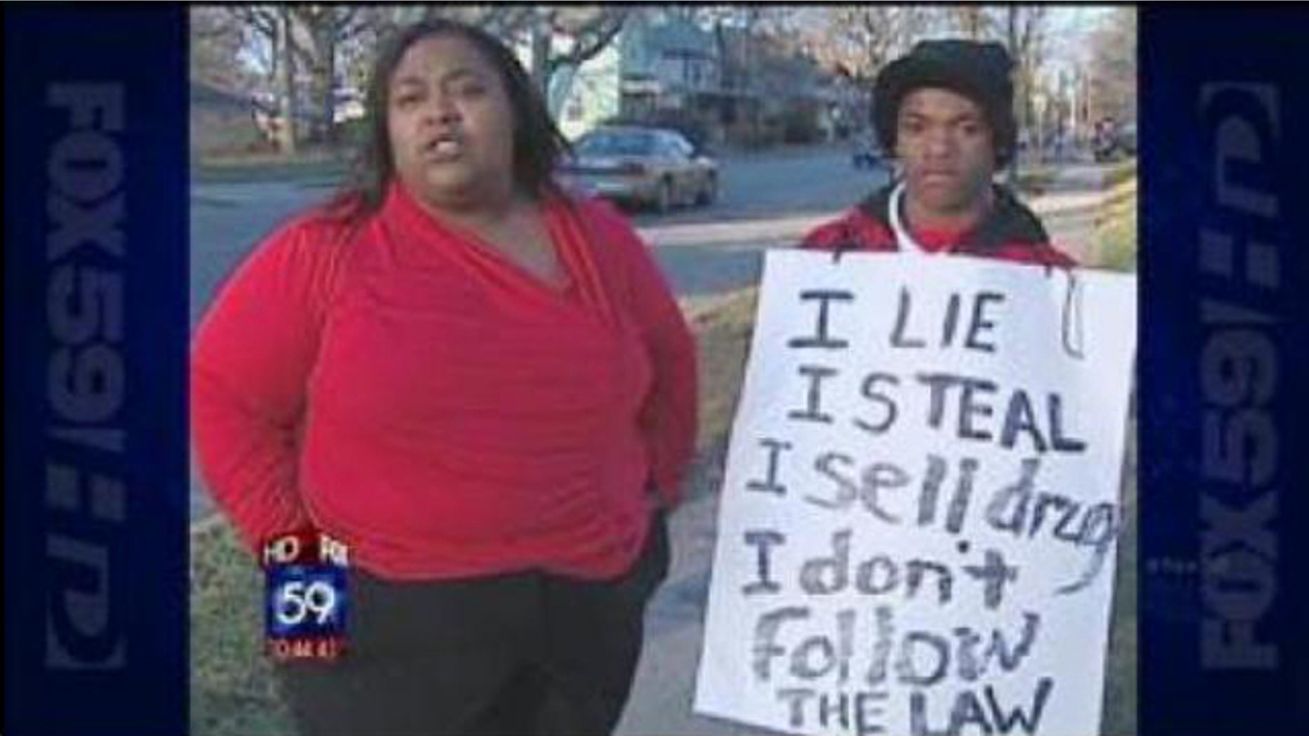 Dynesha Lax, left, forced her 14-year-old son to wear the sign on a street corner.