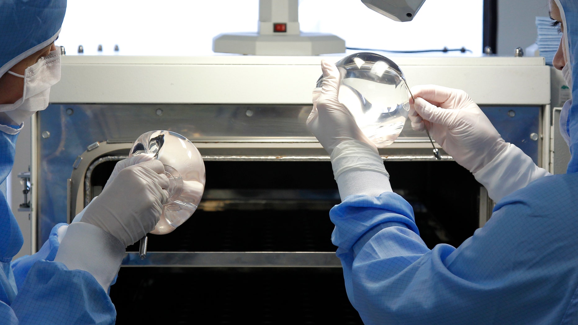 Technicians work in the processing of silicone gel breast implant manufactured by the French company Sebbin laboratories in Boissy-l'Aillerie, northern Paris January 12, 2012. REUTERS/Benoit Tessier