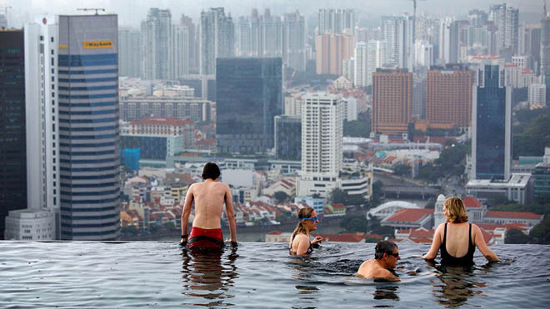 Jan. 3, 2011: Tourists relax in an infinity pool on the roof of the Marina Bay Sands Hotel tower in Singapore.