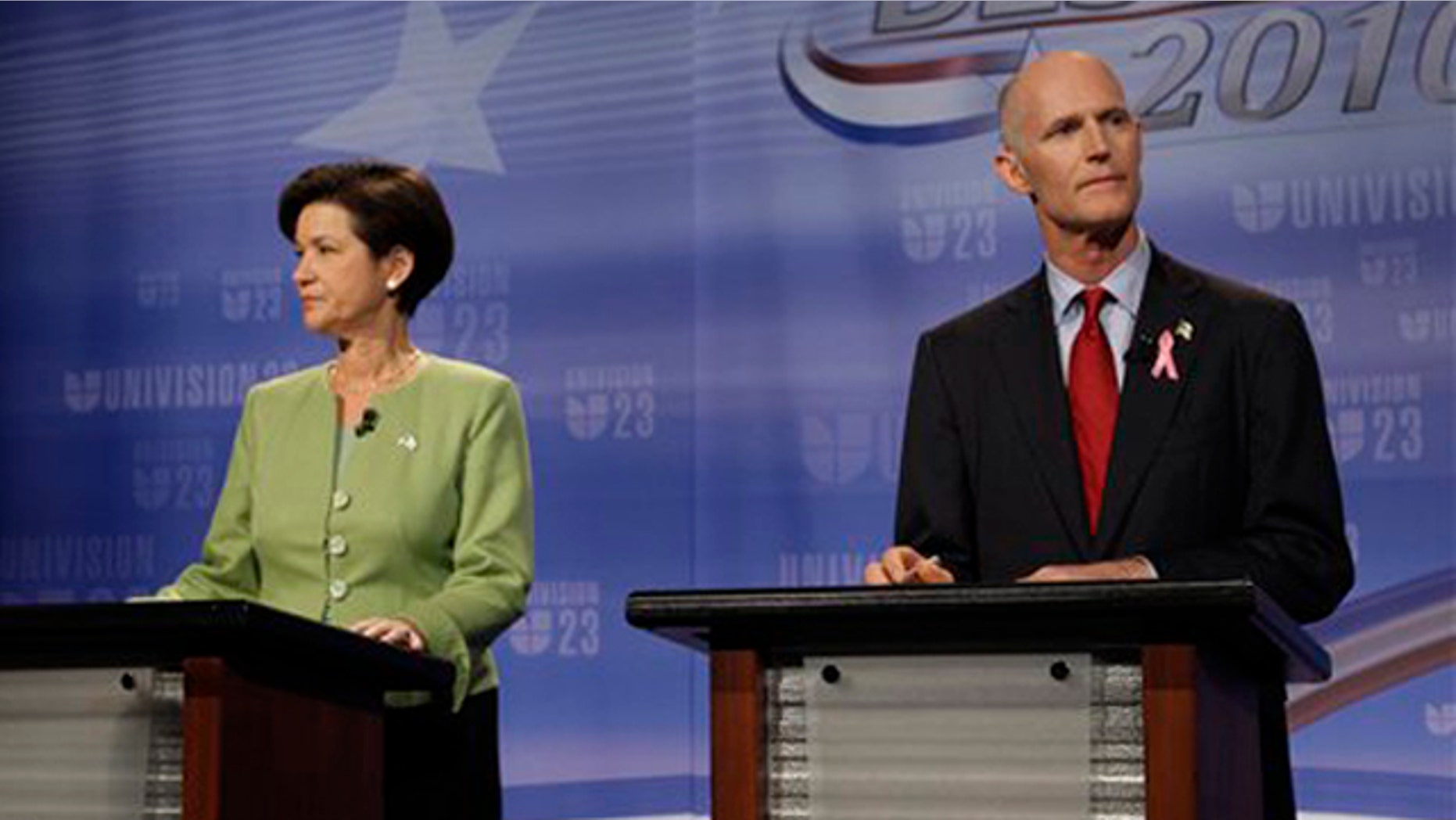Candidates for Florida governor Alex Sink, left, and Rick Scott meet for their first face-to-face debate at Univision's studios in Miami Oct. 8. (AP Photo)