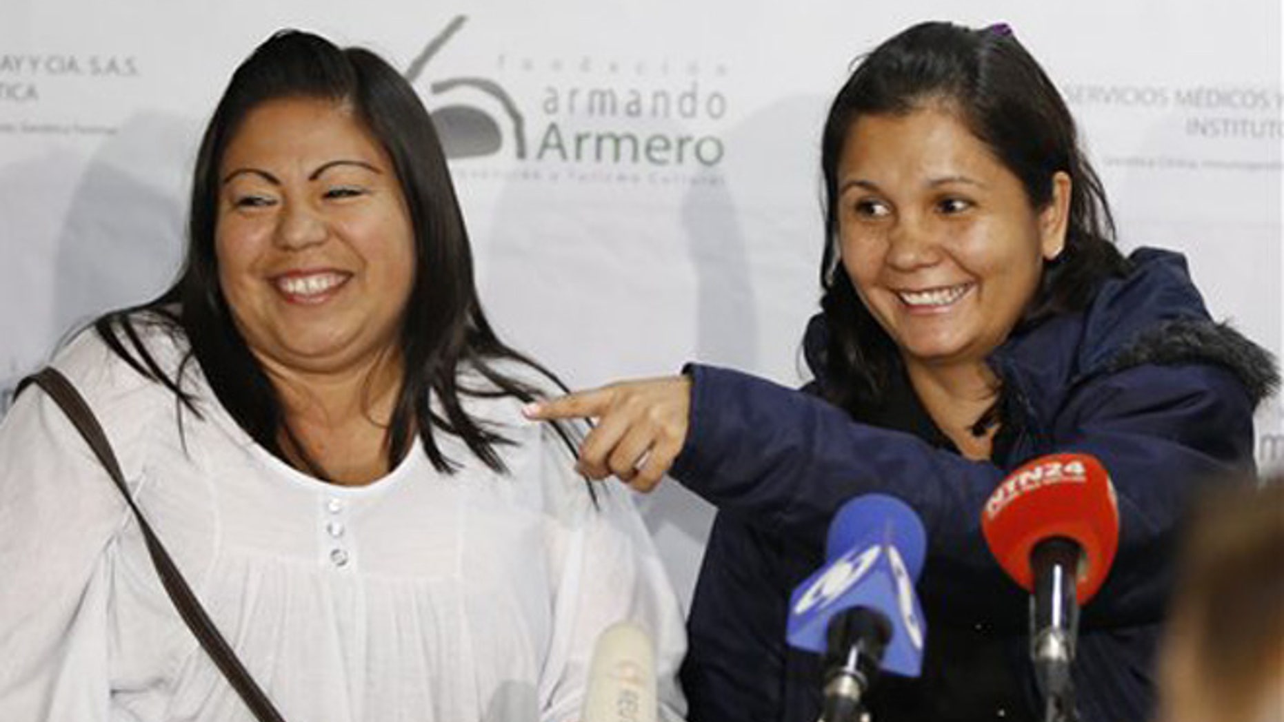 Feb. 25, 2016: Jacqueline Vasquez Sanchez, left, and her sister Lorena Sanchez, right, smile during a press conference in Bogota, Colombia.