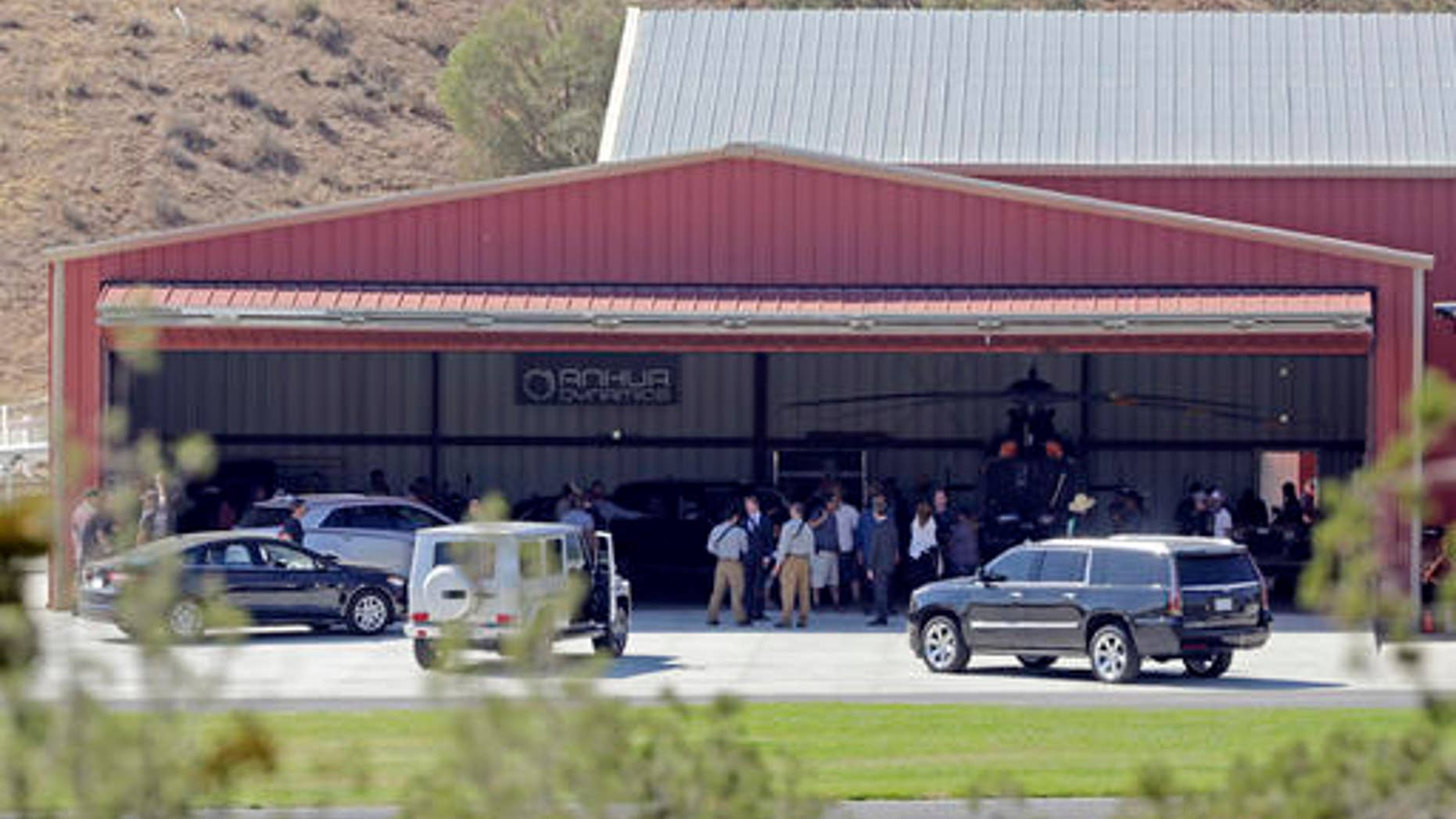FILE - In this Wednesday, July 6, 2016 file photo, members of a film crew stand at Agua Dulce Airpark, a small, rural airport in Agua Dulce, Calif., in northern Los Angeles County. Steve de Castro, a stuntman who was injured in when he was run over by Tom Sizemore while filming the upcoming television series âShooterâ at the site on July 6 has sued the actor and Paramount Pictures over the accident in Los Angeles Superior Court on Friday, Oct. 28, 2016, stating the accident was preventable and left him with lasting injuries that have hampered his ability to work. (AP Photo/Reed Saxon)