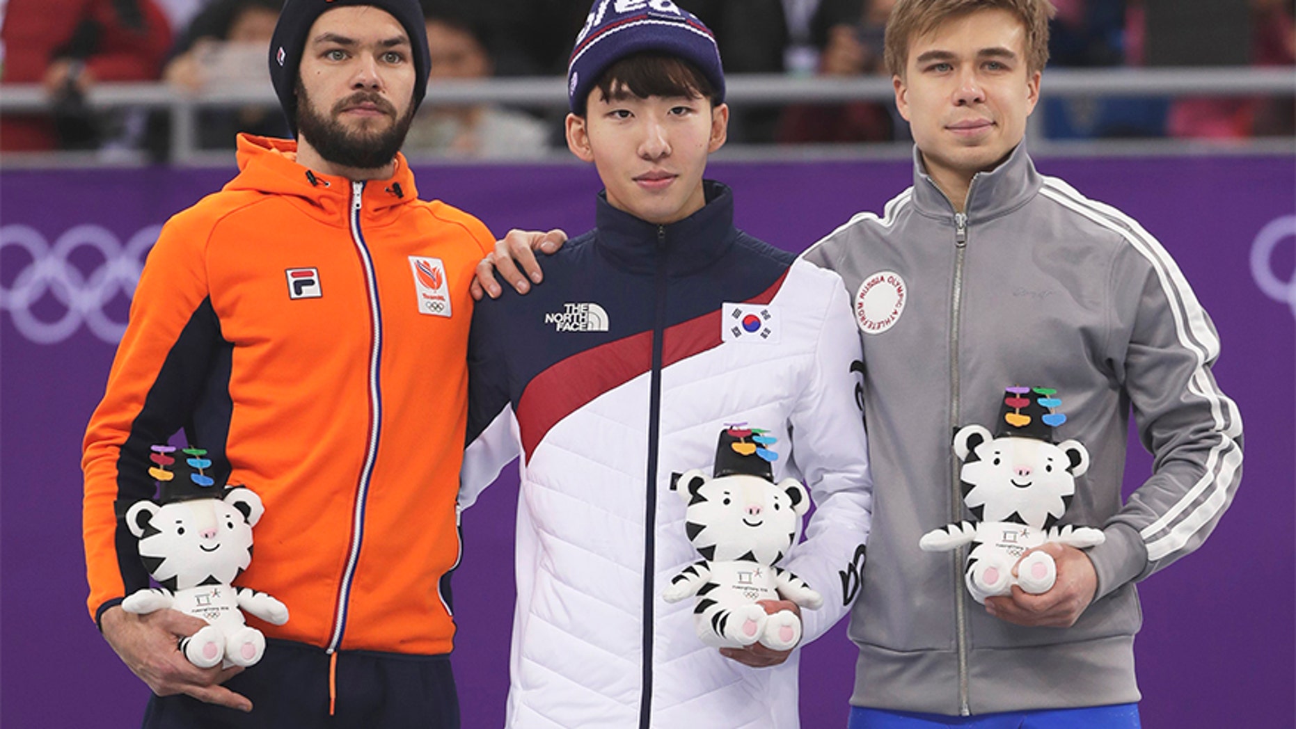 Feb. 10, 2018: Lim Hyojun, center, of South Korea stands on a podium during a Venue Ceremony following his win in the men's 1500 meters short-track speedskating final in the Gangneung Ice Arena at the 2018 Winter Olympics.