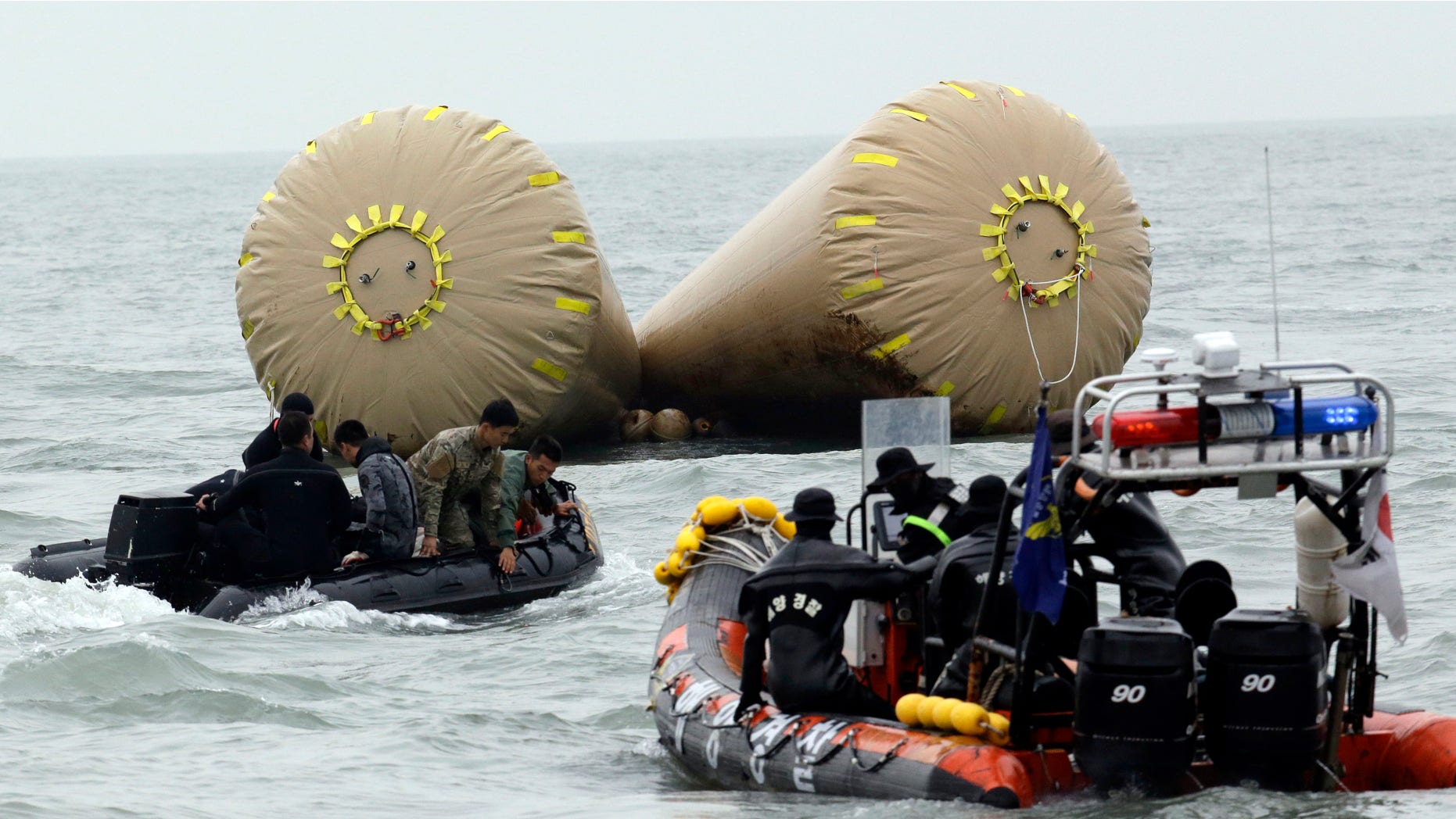 April 19, 2014: South Korean rescue members search passengers believed to have been trapped in the sunken ferry Sewol near the buoys which were installed to mark the area in the water off the southern coast near Jindo, south of Seoul, South Korea.