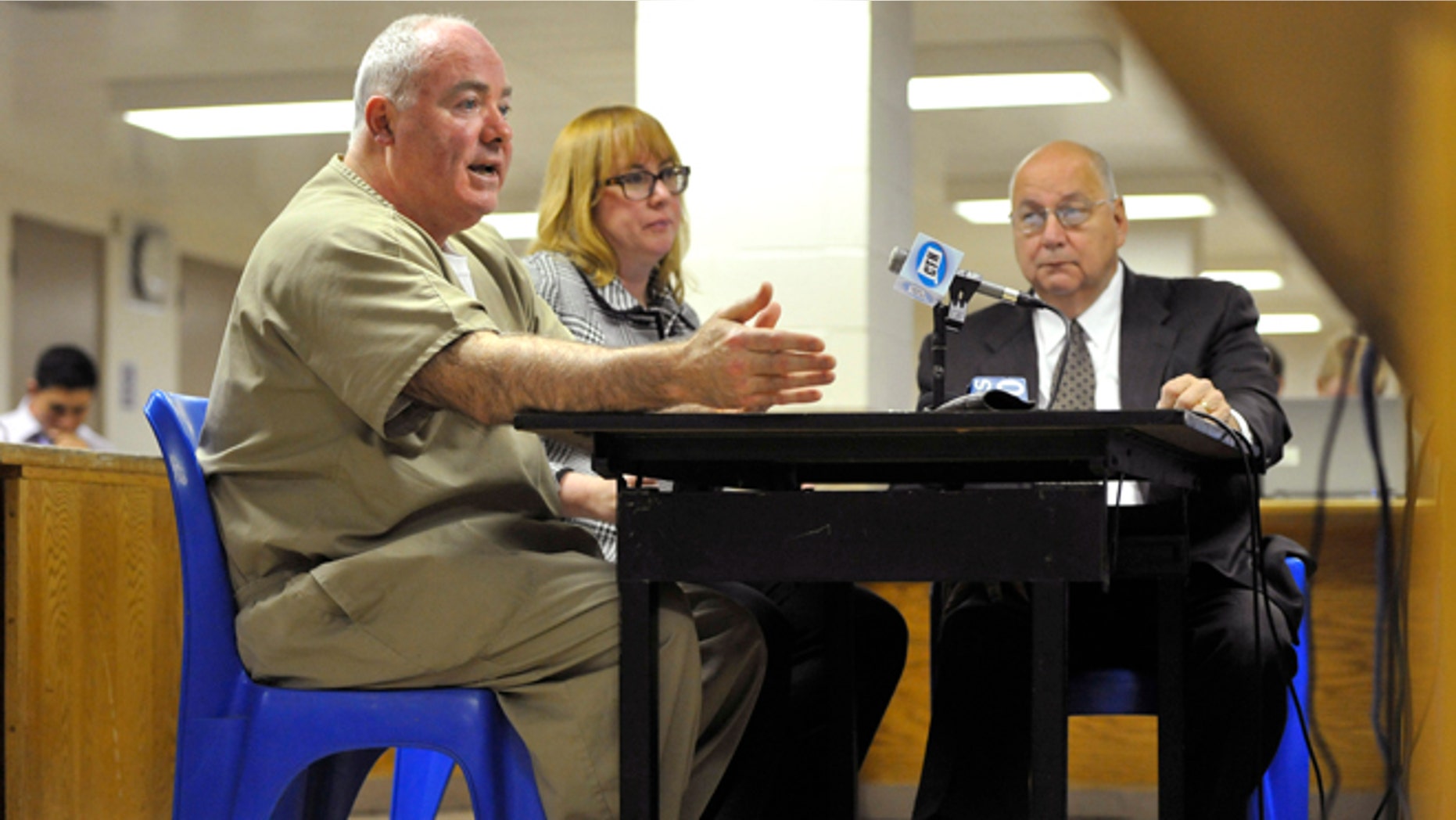 FILE: Oct. 24, 2012: Michael Skakel, left, addresses a parole board with his attorneys Hope Seeley, center, and Hubert Santos, right, at his side during a parole hearing at McDougall-Walker Correctional Institution in Suffield, Conn.