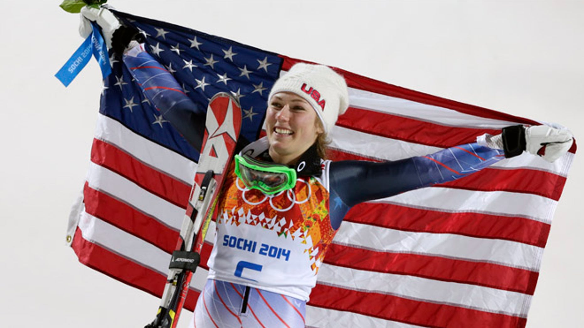 Feb. 21, 2014: Women's slalom gold medal winner Mikaela Shiffrin of the United States poses for photographers with the U.S. flag at the Sochi 2014 Winter Olympics.