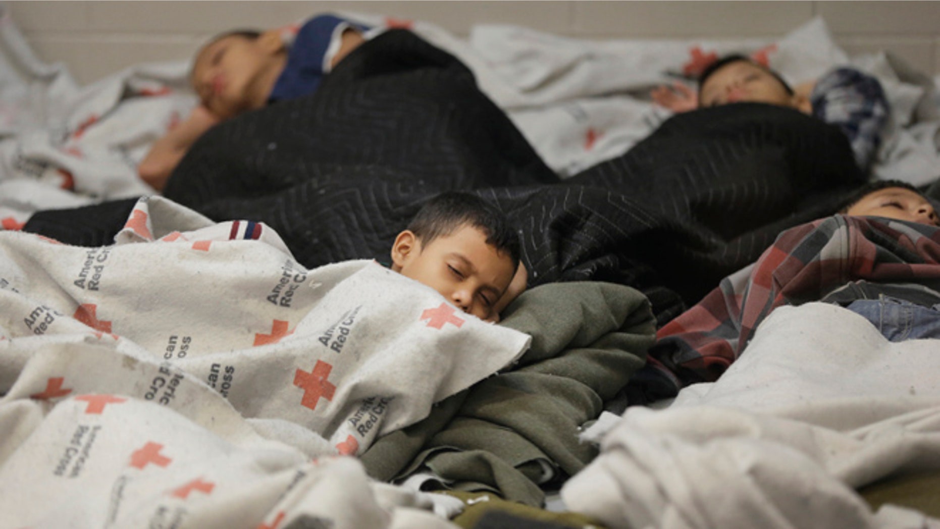 June 18, 2014: Children detainees sleep in a holding cell at a U.S. Customs and Border Protection processing facility in Brownsville, Texas. (AP)