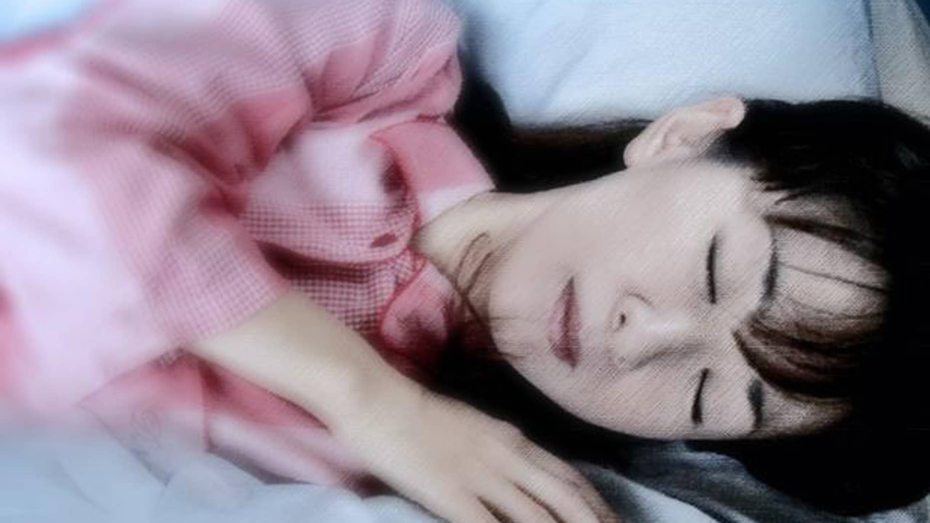 Junko Suzuki, a radio DJ, demonstrates how she sleeps with a "Boyfriend's Arm Pillow" in Tokyo Friday, Sept. 24, 2004. The pillow manufactured by linen maker Kameo Corp. consists of a headless torso and a stuffed arm that curls around the sleeper. It might make some people uneasy but have sold about 1,000 in Japan since the product went on the market last December. The maker says the pillow is not only an emotional comfort, but that its shape keeps the body balanced by supporting the sleeper from both sides. (AP Photo/Koji Sasahara)