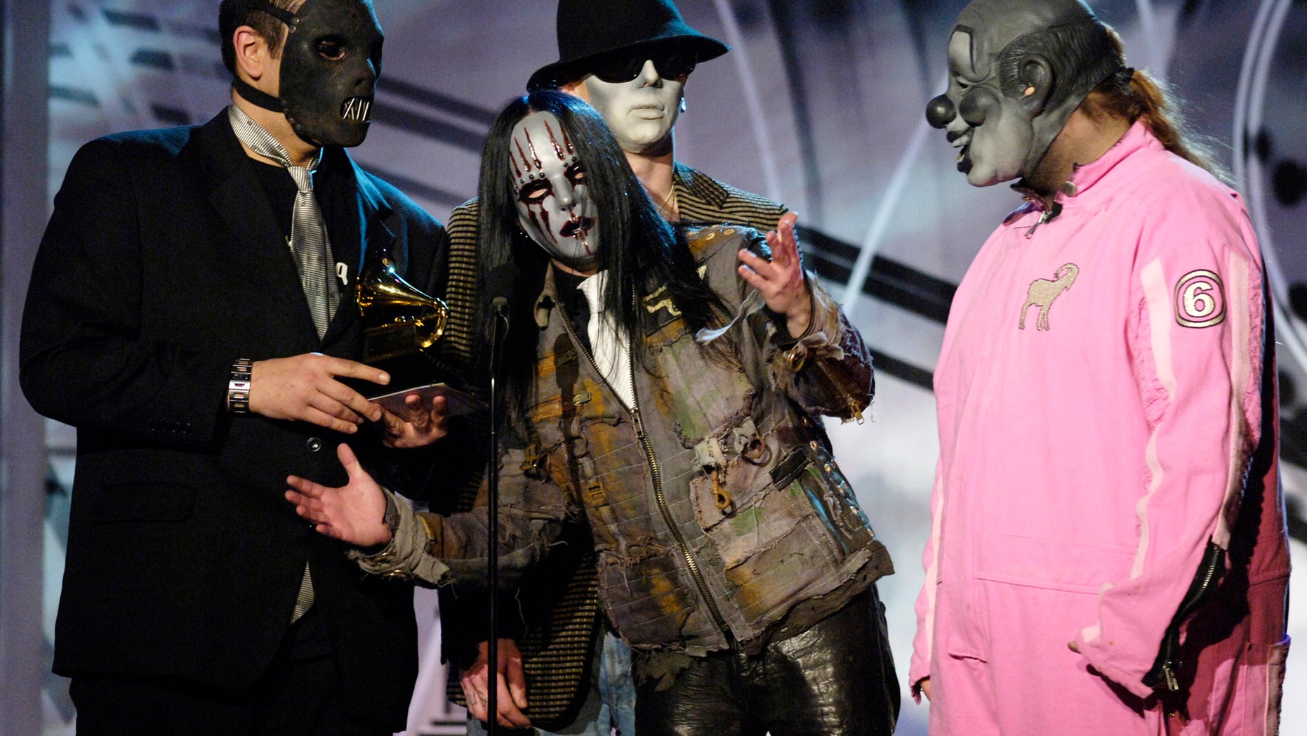 Members of music group Slipknot pose with their award for best metal performance for "Before I Forget" at the 48th annual Grammy Awards in Los Angeles February 8, 2006.REUTERS/Chris Pizzello - RTR16026