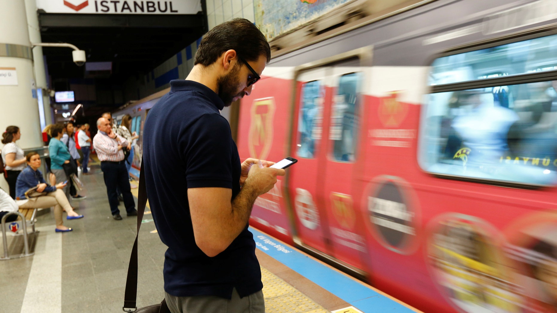 File photo: A passenger uses his smartphone as he waits for the train at a subway station in Istanbul, Turkey, June 14, 2017. (REUTERS/Murad Sezer)