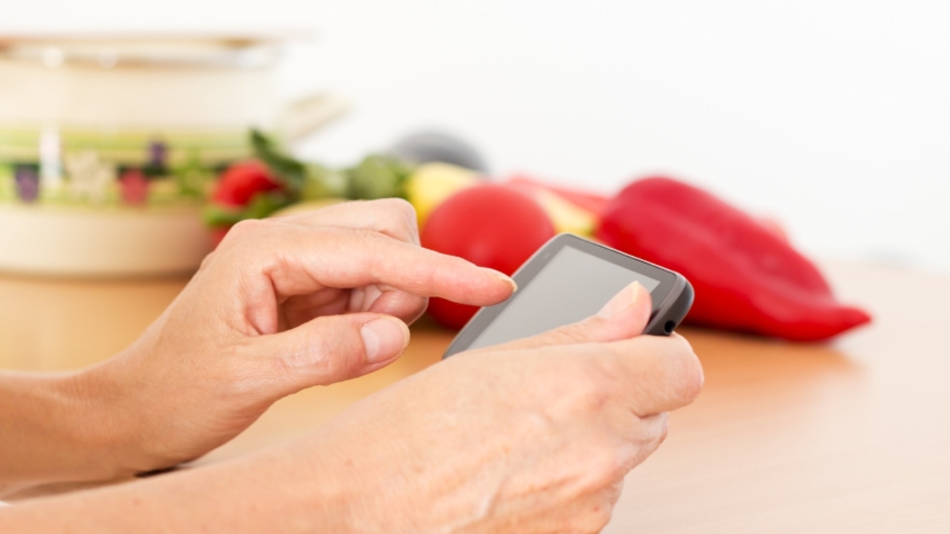Woman reading a recipe on her smart phon.