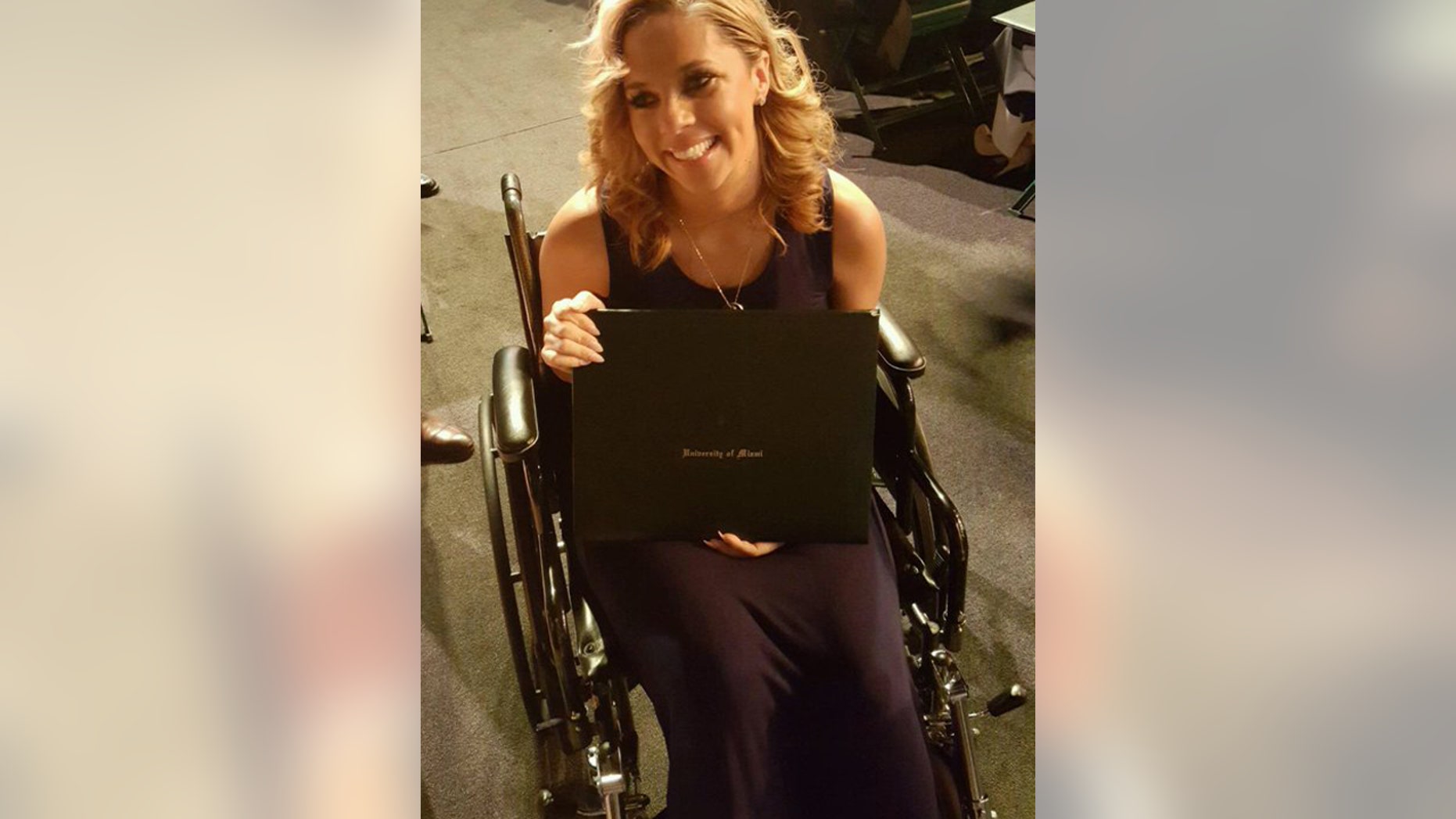 May 5, 2016: Racquel Smith, widow of former New Orleans Saints defensive lineman Will Smith, poses with her husband's degree from the University of Miami in Coral Gables, Fla.