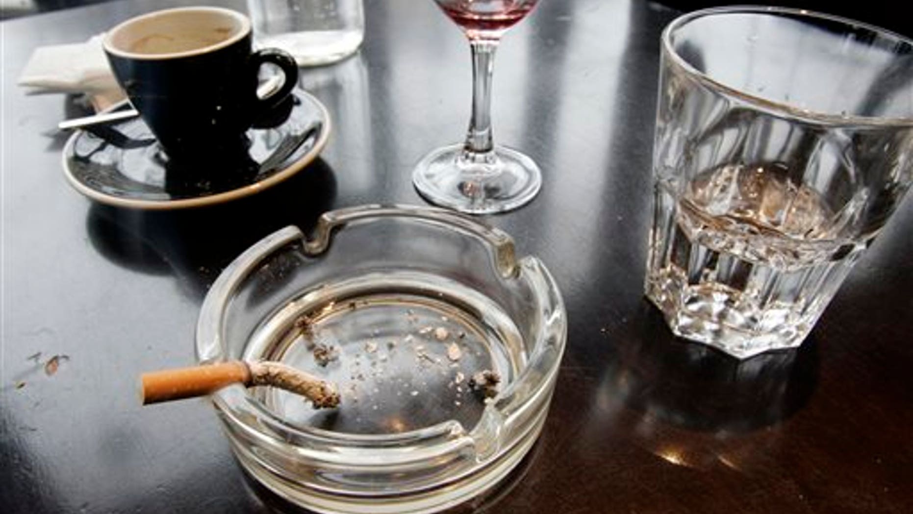 FILE - In this Thursday, Dec. 27, 2007 file photo, a cigarette burns out in an ashtray after lunch at a restaurant in Paris. According to a report released on Wednesday, Feb. 4, 2015, for the first time, lung cancer has passed breast cancer as the leading cause of cancer deaths for women in rich countries, according to the American Cancer Society based on new numbers from the International Agency for Research on Cancer. (AP Photo/Francois Mori)