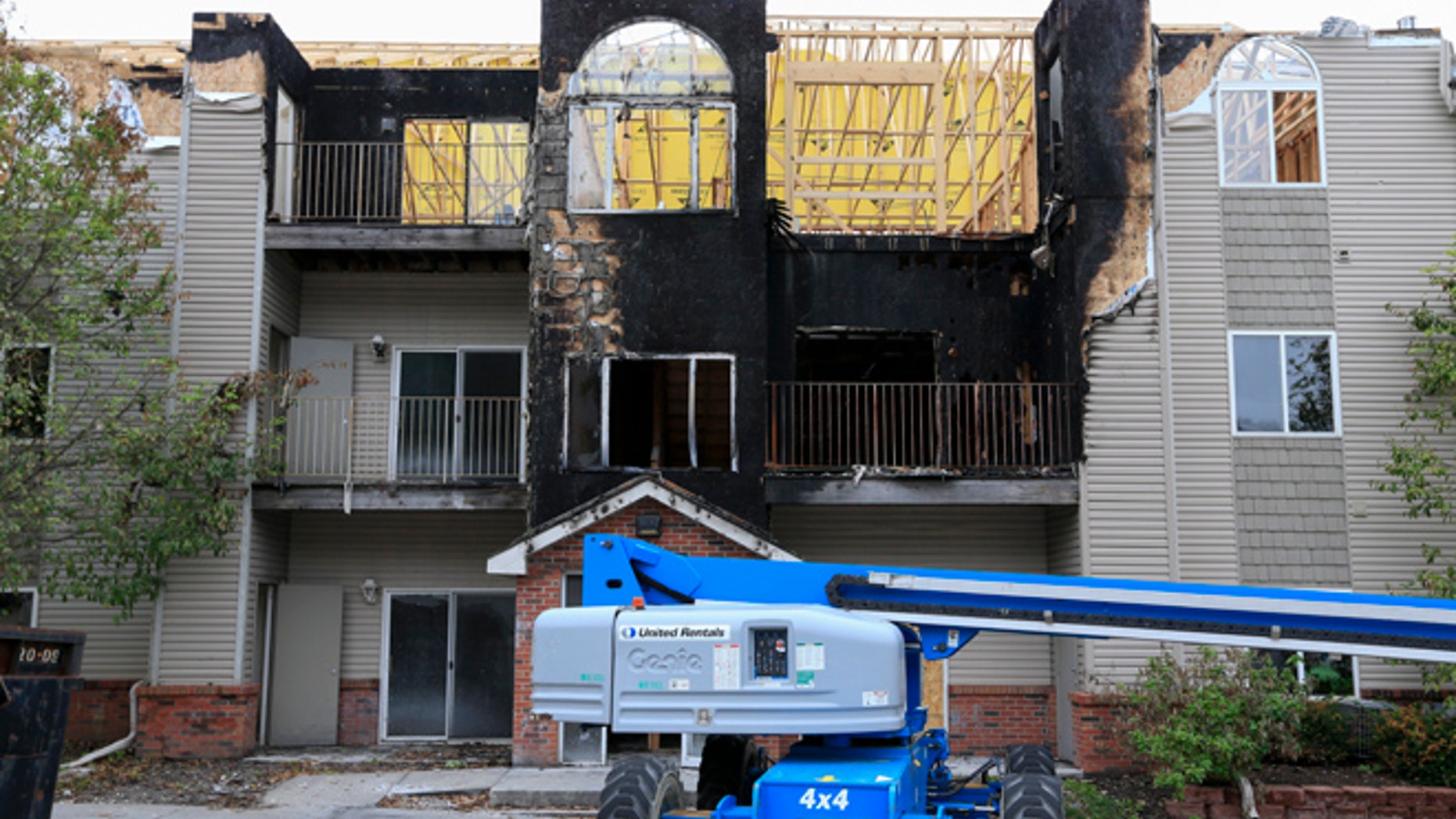 In this Sept. 14, 2016, photo, restoration work is performed at a Bellevue, Neb., apartment complex which was hit twice by fire.