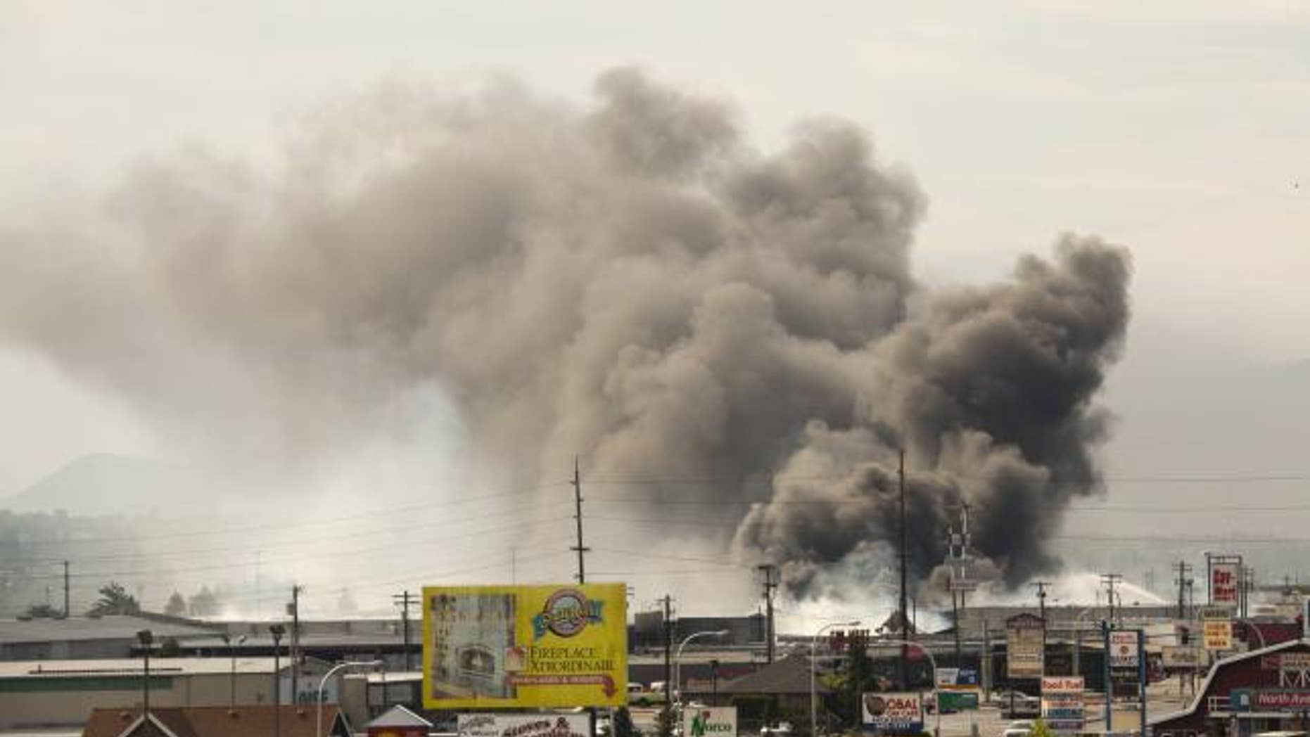 June 29, 2015: Smoke from burning commercial buildings that were ignited by the Sleepy Hollow fire rises above Wenatchee, Washington.