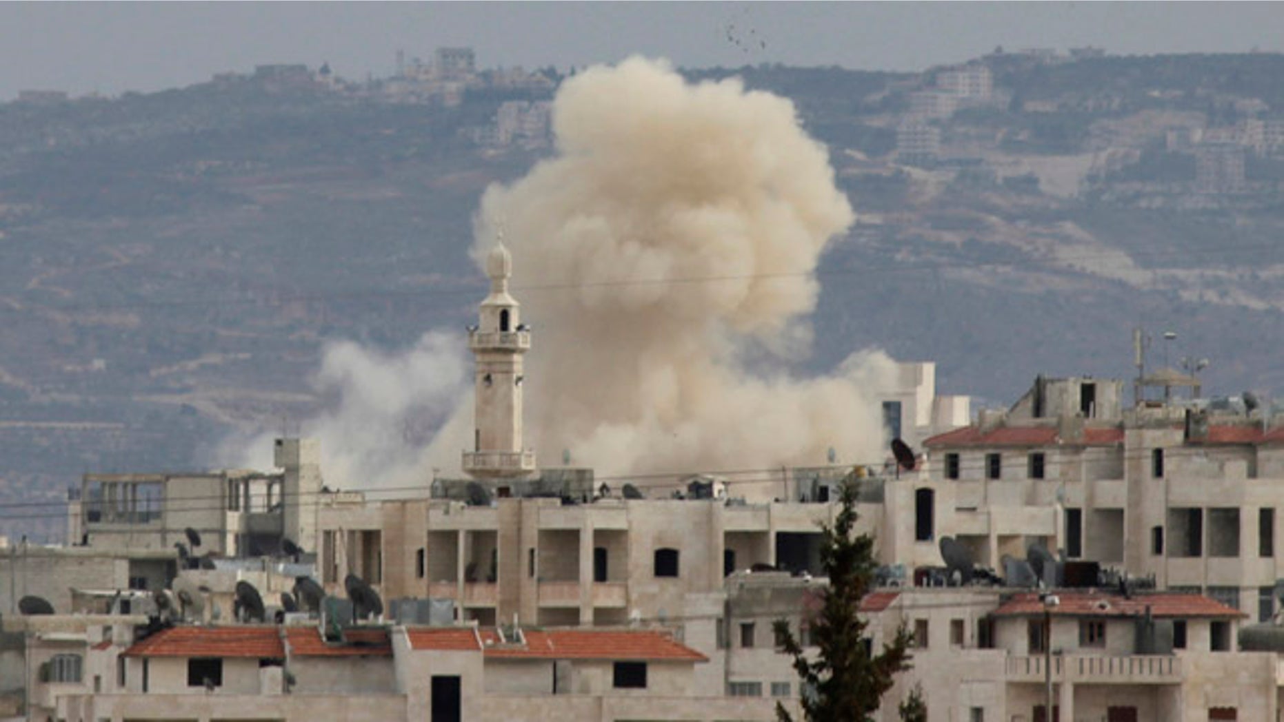 March 11: Smoke rises as Idlib city is shelled by government forces. Activists said at least four people were killed in Idlib on Sunday after troops and tanks moved in a day earlier.