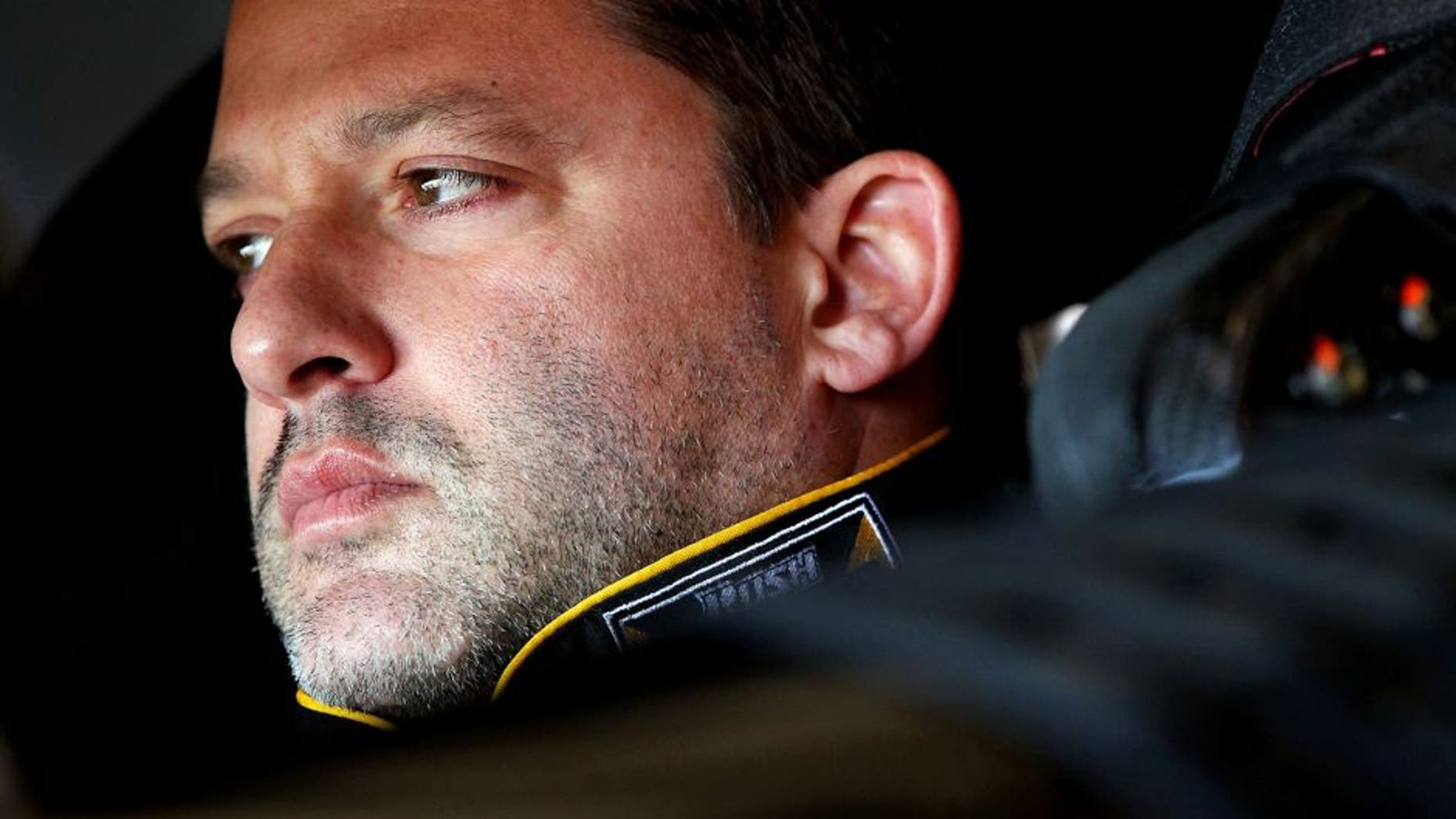 FONTANA, CA - MARCH 23: Tony Stewart, driver of the #14 Rush Truck Centers/Mobil 1 Chevrolet, sits in his car during practice for the NASCAR Sprint Cup Series Auto Club 400 at Auto Club Speedway on March 23, 2013 in Fontana, California. (Photo by Jonathan Ferrey/Getty Images)