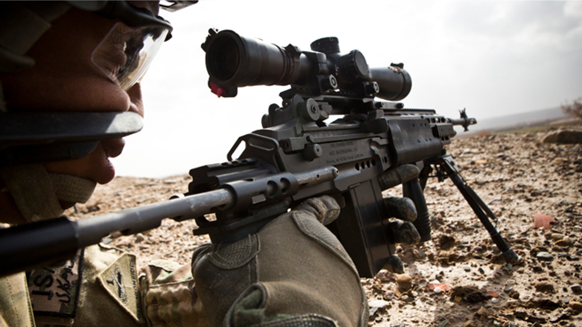 Feb. 3, 2013: A U.S. Army sniper with Charlie Company, 36th Infantry Regiment, 1st Armored Division looks down the scope of his rifle during a mission near Command Outpost Pa'in Kalay in Maiwand District, Kandahar Province.