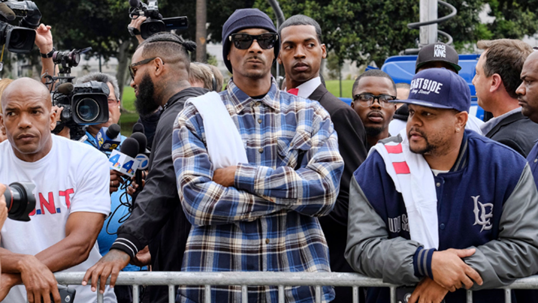 Rapper Snoop Dogg, center, leads a march in support of unification outside of the graduation ceremony for the latest class of Los Angeles Police recruits in Los Angeles, Friday, July 8, 2016. The group were looking to bring a peaceful gathering of support after the killings of multiple police officers in Dallas on Thursday night. (AP Photo/Richard Vogel)