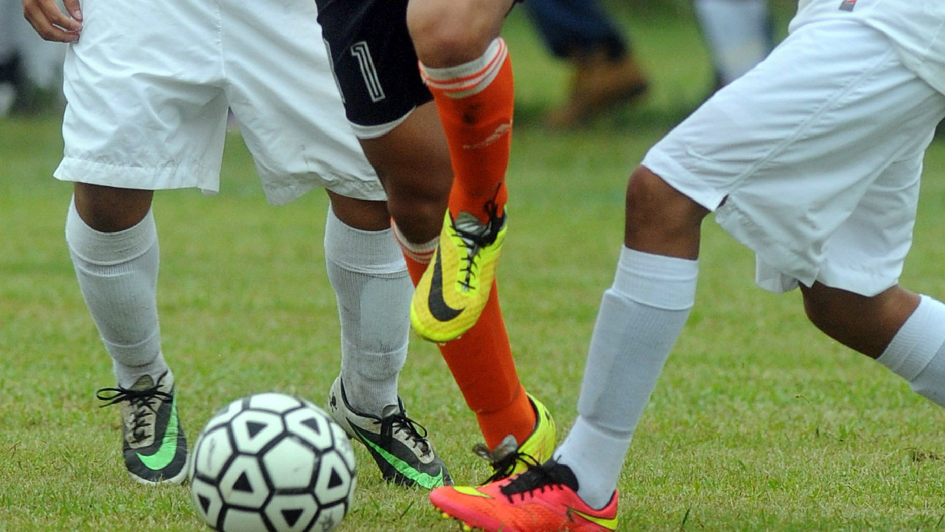 FILE - In this Wednesday, Sept. 24, 2014 file photo, students compete in a high school soccer game in Burgaw, N.C. A study released on Monday, Sept. 11, 2016 found soccer injuries are sending increasing numbers of U.S. youth to emergency rooms, a trend driven partly by young players with concussions seeking urgent medical care. The findings, based on 25 years of data, partly reflect soccer's growing popularity. (AP Photo/Wilmington Star-News, Mike Spencer)