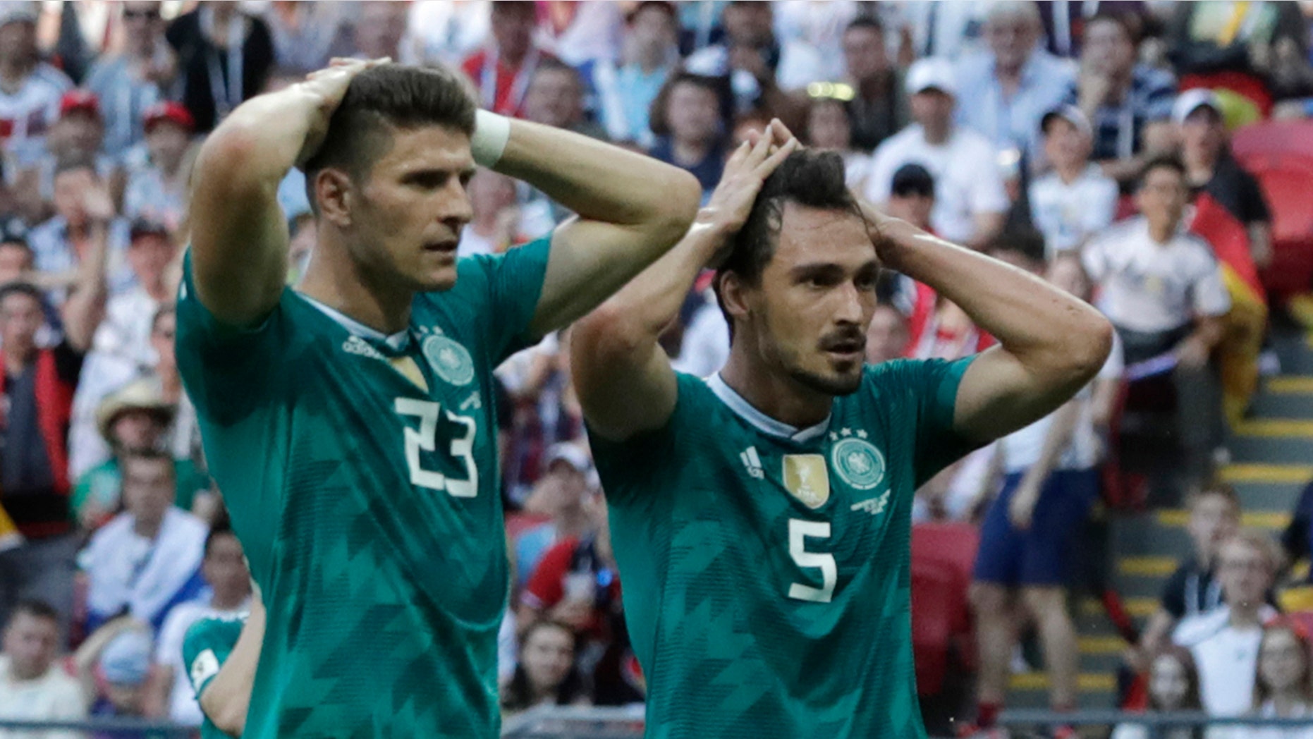 Germany's Mario Gomez, left, and Germany's Mats Hummels, right, hold their heads after failing to score during the group F match between South Korea and Germany.
