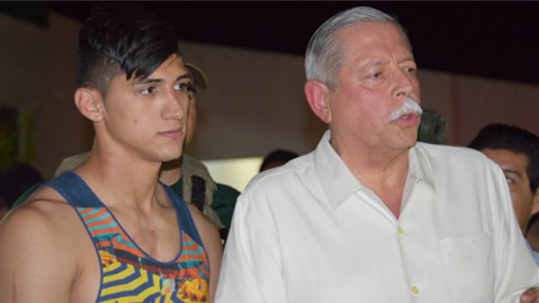 Mexican soccer player Alan Pulido, left, stands next to Tamaulipas State Gov. Egidio Torre Cantu after Pulido was rescued from kidnappers early Monday, May 30, 2016 in Ciudad Victoria, the capital of Tamaulipas State, Mexico. Mexican authorities say Pulido, a forward with Olympiacos in the Greek league, has been rescued safe and sound after an hours-long kidnapping in the northeast border state of Tamaulipas. (AP Photo/Alfredo Pena)