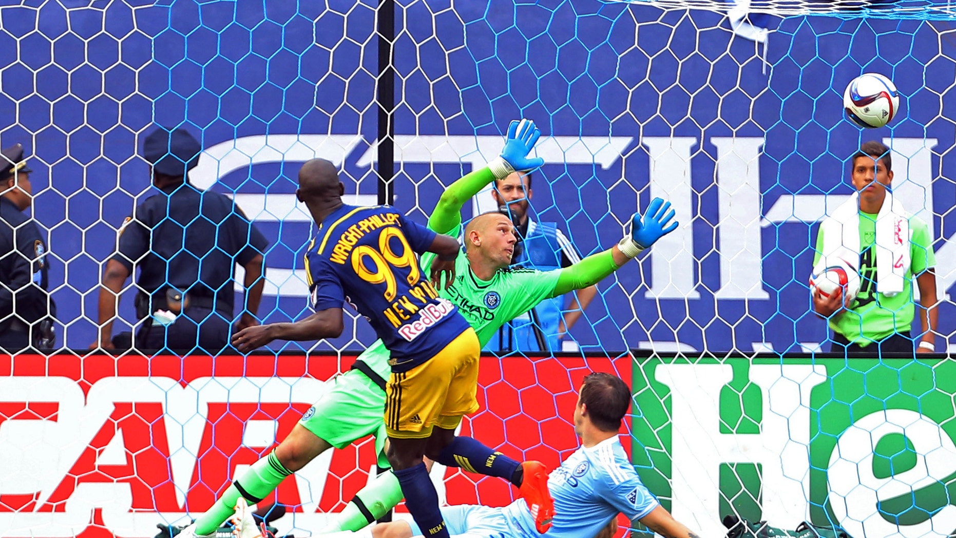 File photo - Jun 28, 2015; New York Red Bulls forward Bradley Wright-Phillips (99) scores a goal past New York City FC goalkeeper Josh Saunders (12) during the second half of a soccer game at Yankee Stadium, New York. (Adam Hunger-USA TODAY Sports)