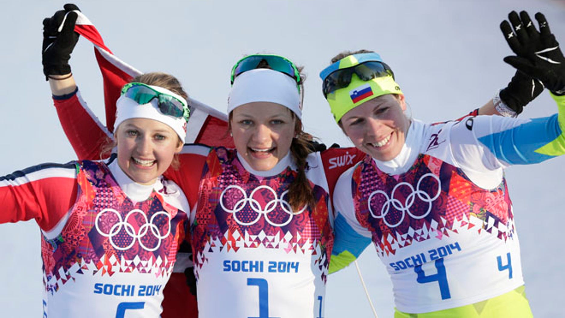 Feb. 11, 2014: Norway's gold medal winner Maiken Caspersen Falla is flanked by silver medal winner Ingvild Flugstad Oestberg from Norway, left, and Slovenia's bronze medal winner Vesna Fabjan after the women's cross-country sprint the 2014 Winter Olympics in Krasnaya Polyana, Russia.