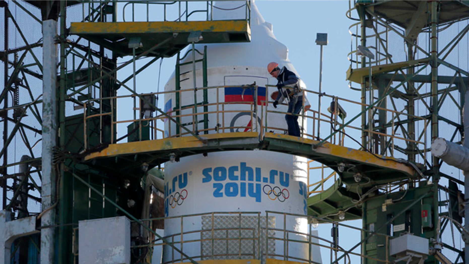 Nov. 5, 2013: A Baikonur Cosmodrome staff member works at Russia's Soyuz-FG booster rocket, emblazoned with the emblem of the Winter Olympics in Sochi, loaded with Soyuz TMA-11M space capsule that will carry new crew to the International Space Station (ISS) as the rocket is transported from hangar to the launch pad at the Russian leased Baikonur cosmodrome, Kazakhstan. For the first time, it will also carry an Olympic torch to space as part of the ongoing Olympic torch relay. The torch will be brought back along with the station's current crew. The rocket is scheduled to blast off on Thursday, Nov. 7.