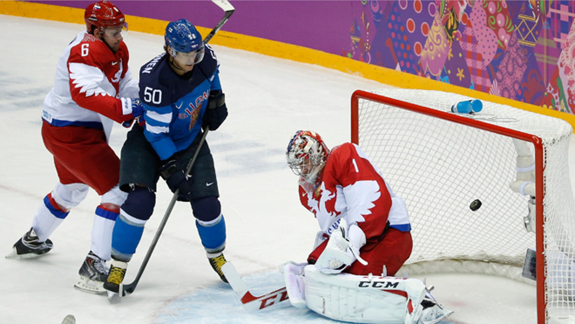 Feb. 19, 2014: Finland forward Juhamatti Aaltonen (50) scores against Russia defenseman Nikita Nikitin, left, and Russia goaltender Semyon Varlamov in the first period of a men's quarterfinal ice hockey game at the 2014 Winter Olympics in Sochi, Russia.