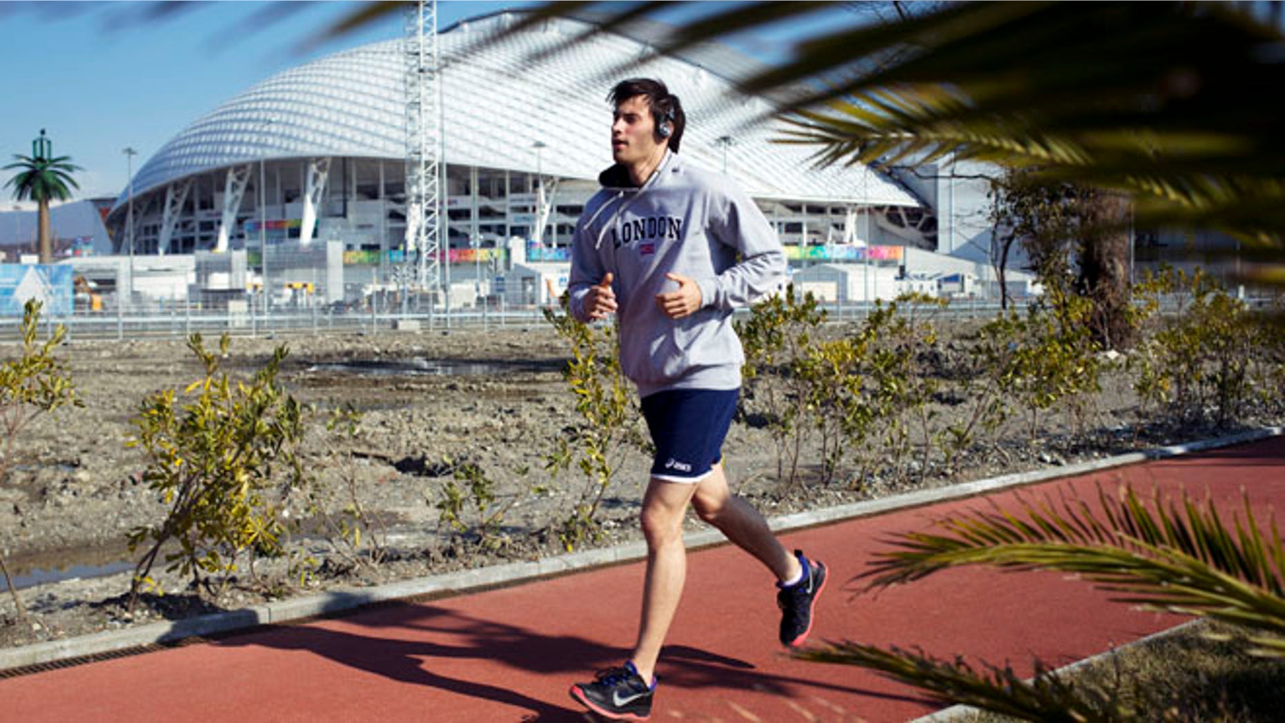 Feb. 10, 2014: A man runs at a boardwalk near the Fisht Olympic Stadium in Olympic Park during the 2014 Winter Olympics in Sochi, Russia.
