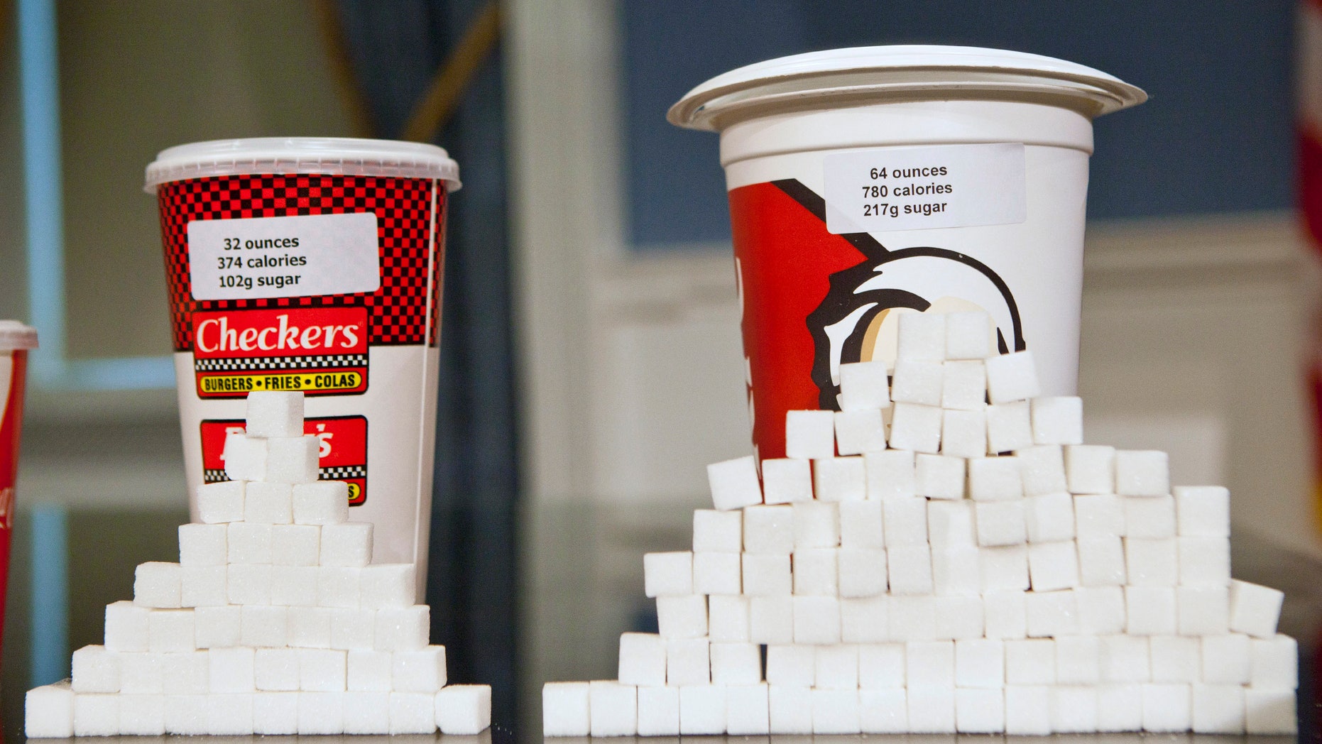 Soft drink cups sized (L-R) at 32 ounces and 64 ounces are displayed at a news conference at City Hall in New York, May 31, 2012. (REUTERS/Andrew Burton)
