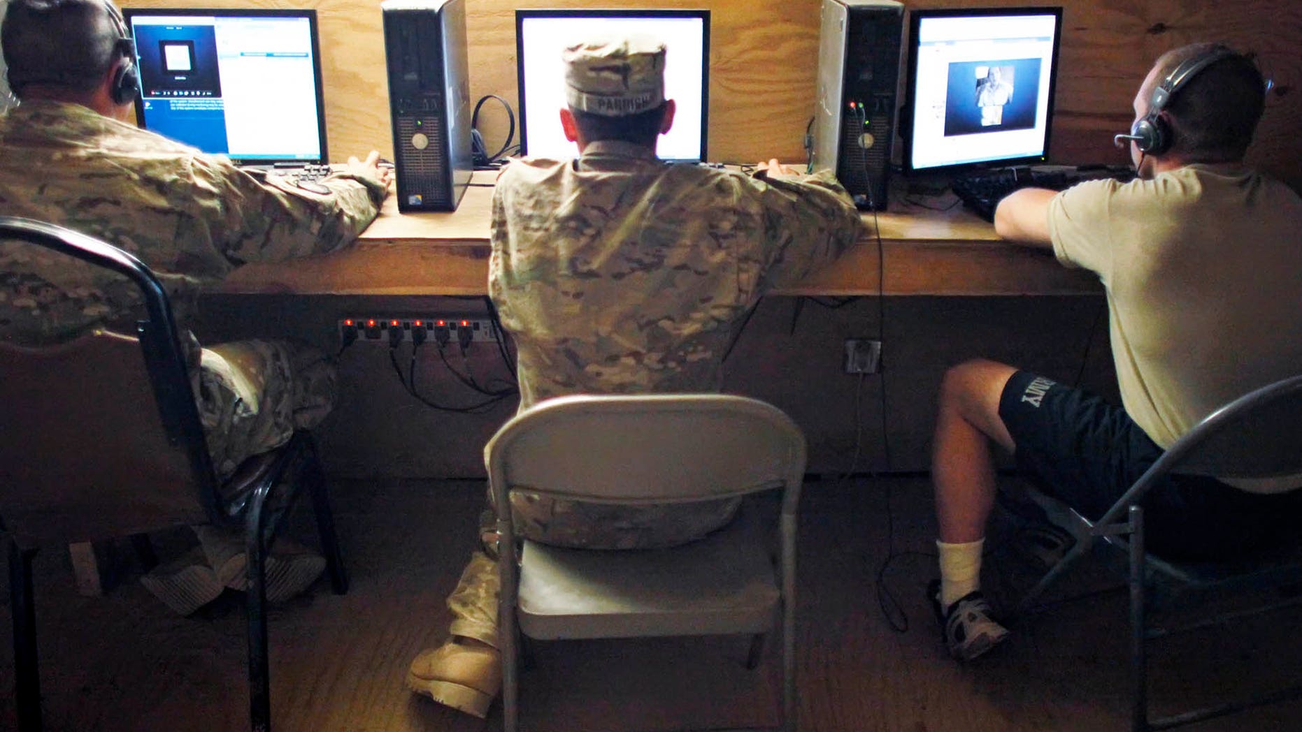 U.S. Army soldiers use computers at Combat Outpost Nolen in the Arghandab Valley north of Kandahar April 14, 2011. (Reuters)
