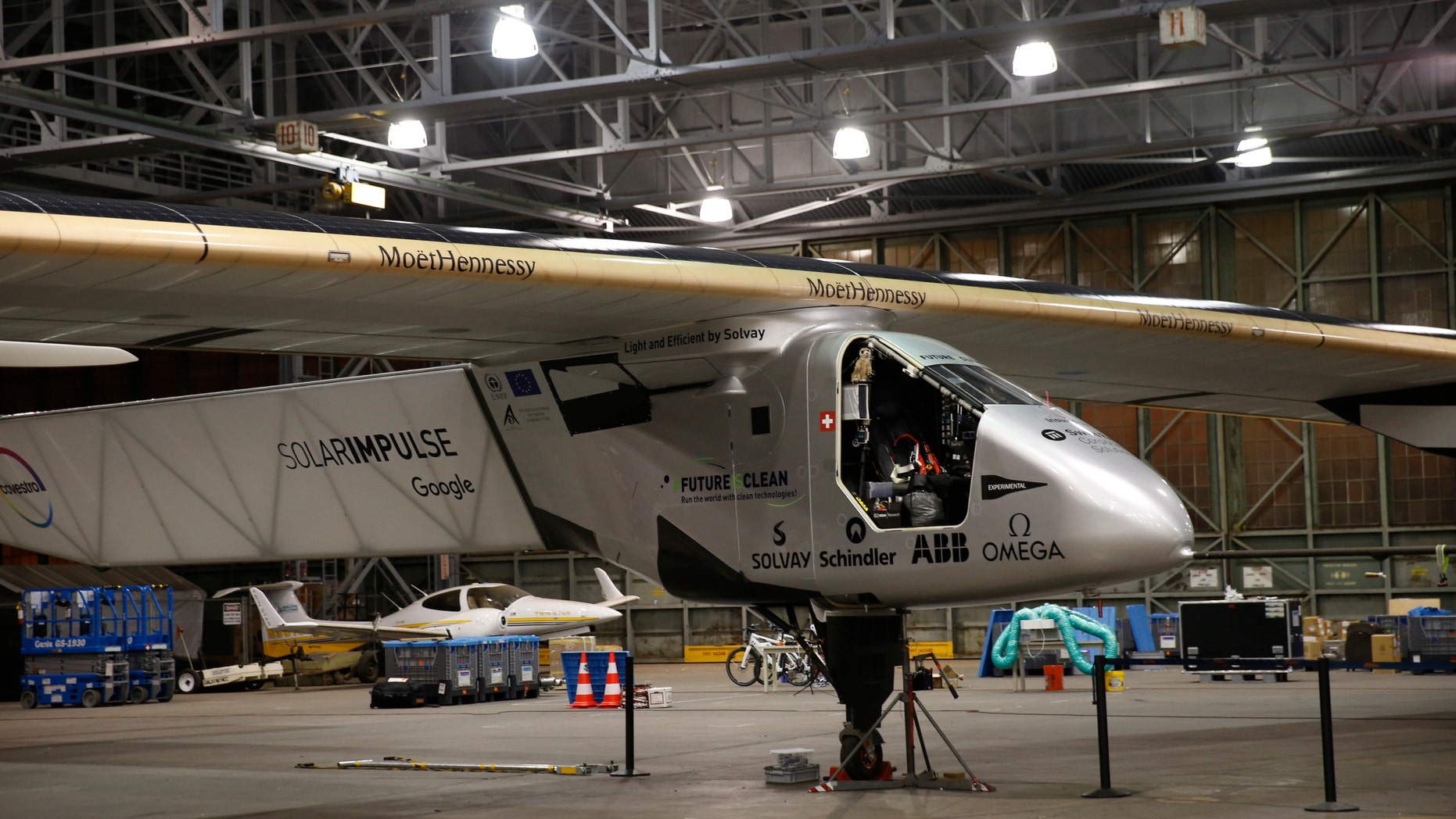 Ground crew prepare for the departure of the Solar Impulse 2 solar plane from the Kalaeloa Airport, Thursday, April 21, 2016, in Kapolei, Hawaii. The Solar Impulse team landed in the islands in July after a record-breaking flight from Japan. (AP Photo/Marco Garcia)