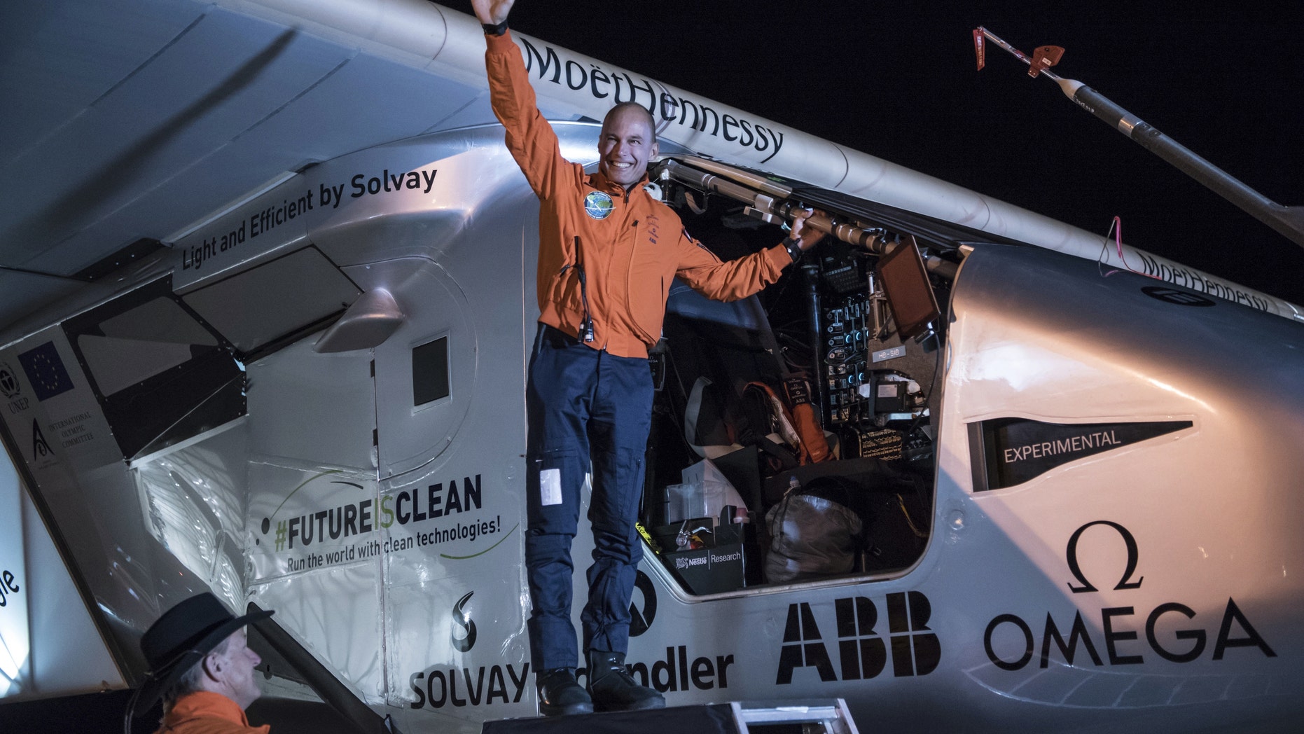 In this photo provided by Solar Impulse, Bertrand Piccard acknowledges the crowd prior to the takeoff of "Solar Impulse 2," in Goodyear, Ariz., Thursday, May 12, 2016. The solar-powered airplane that landed in Arizona last week is headed to Oklahoma on the latest leg of its around-the-world journey. (Jean Revillard/Solar Impulse via AP)