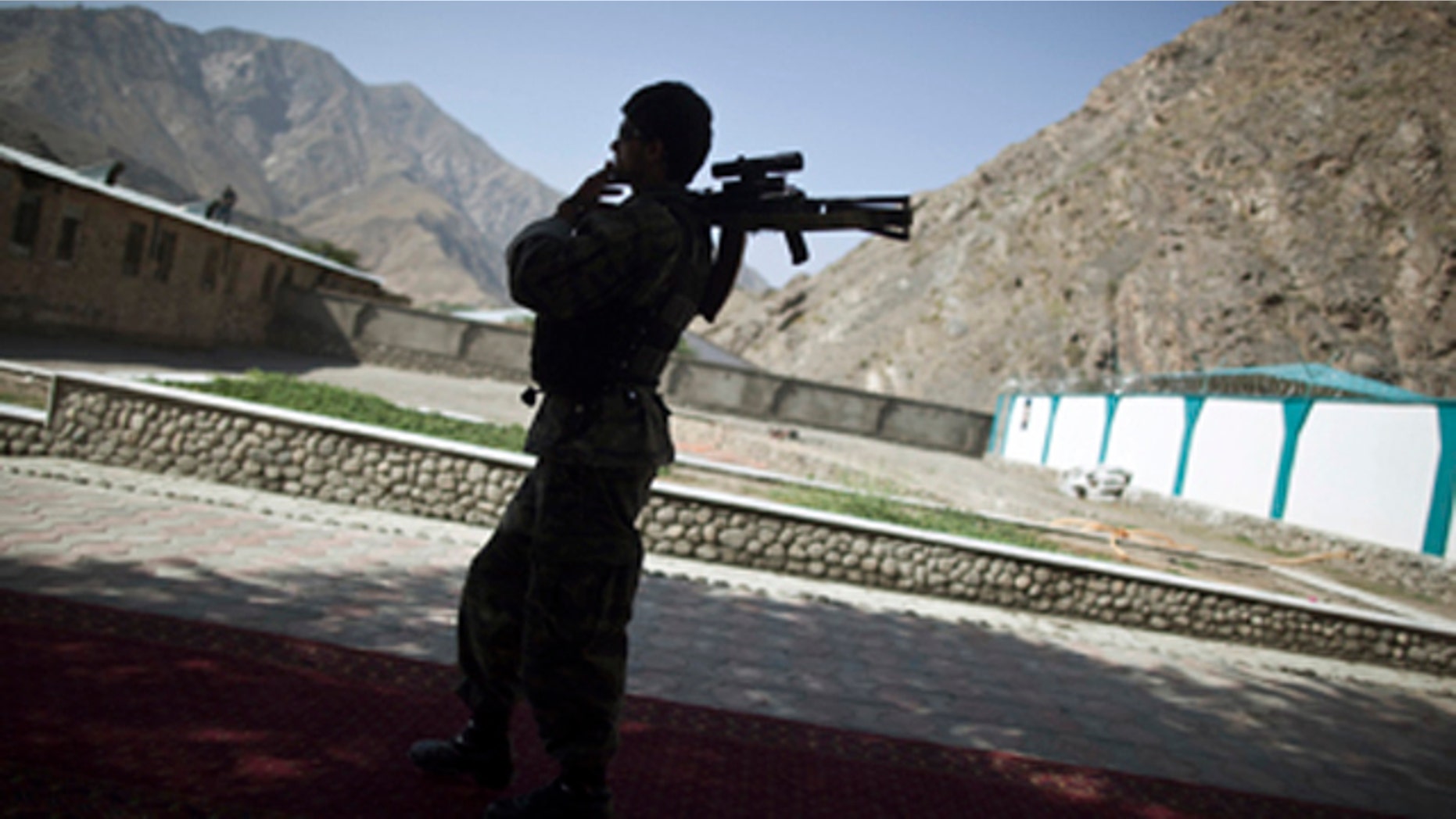 FILE 2011: An Afghan security personnel holds his rifle as he keeps watch during the security handover ceremony in Panjshir province.