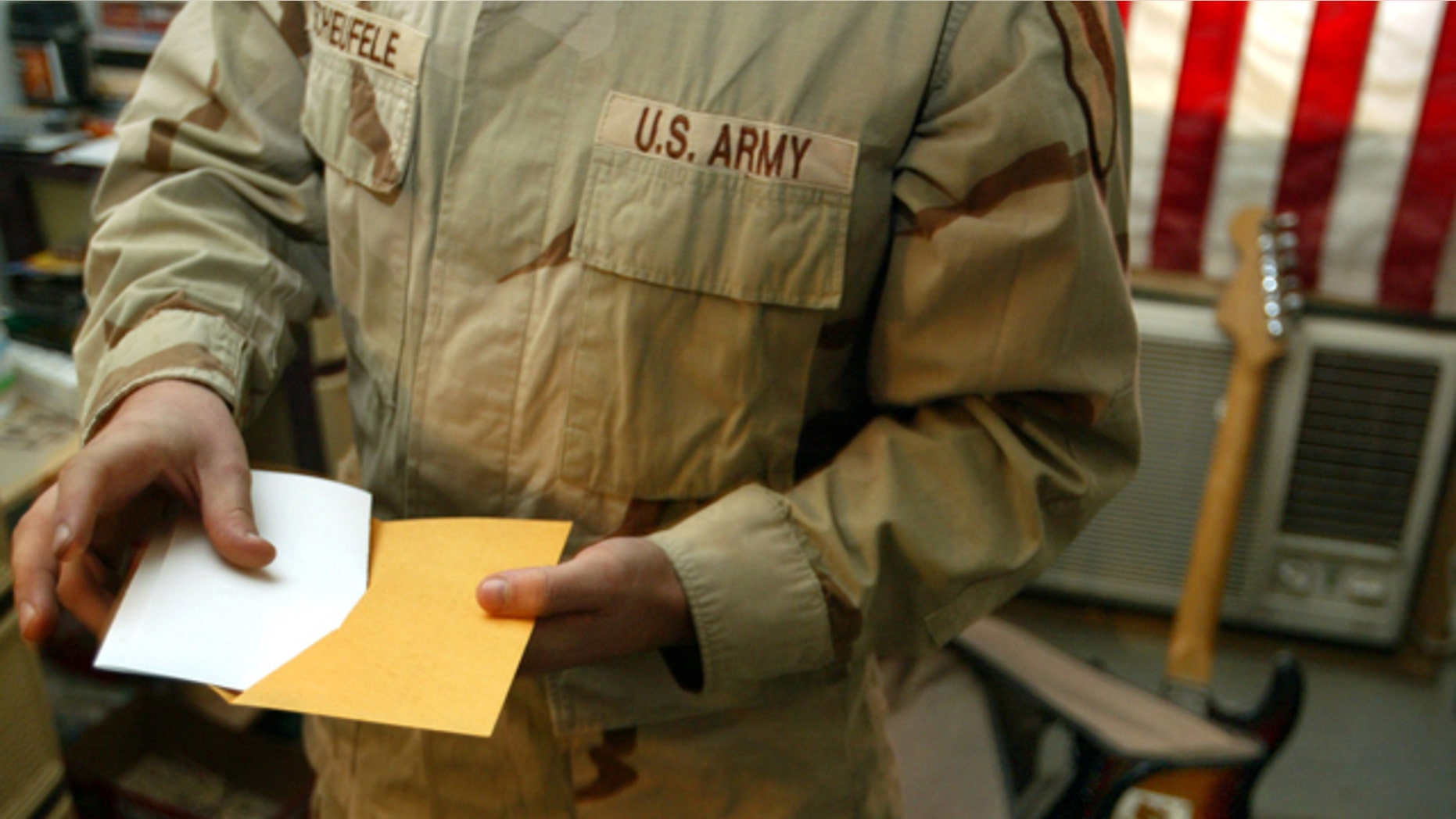 Oct. 26, 2004: U.S. Army Sgt. George Scheufele prepares to mail in his completed absentee ballot after voting in the American Presidential and Congressional election while at Camp Eagle in the battle-torn Sadr City neighborhood of Baghdad, Iraq.