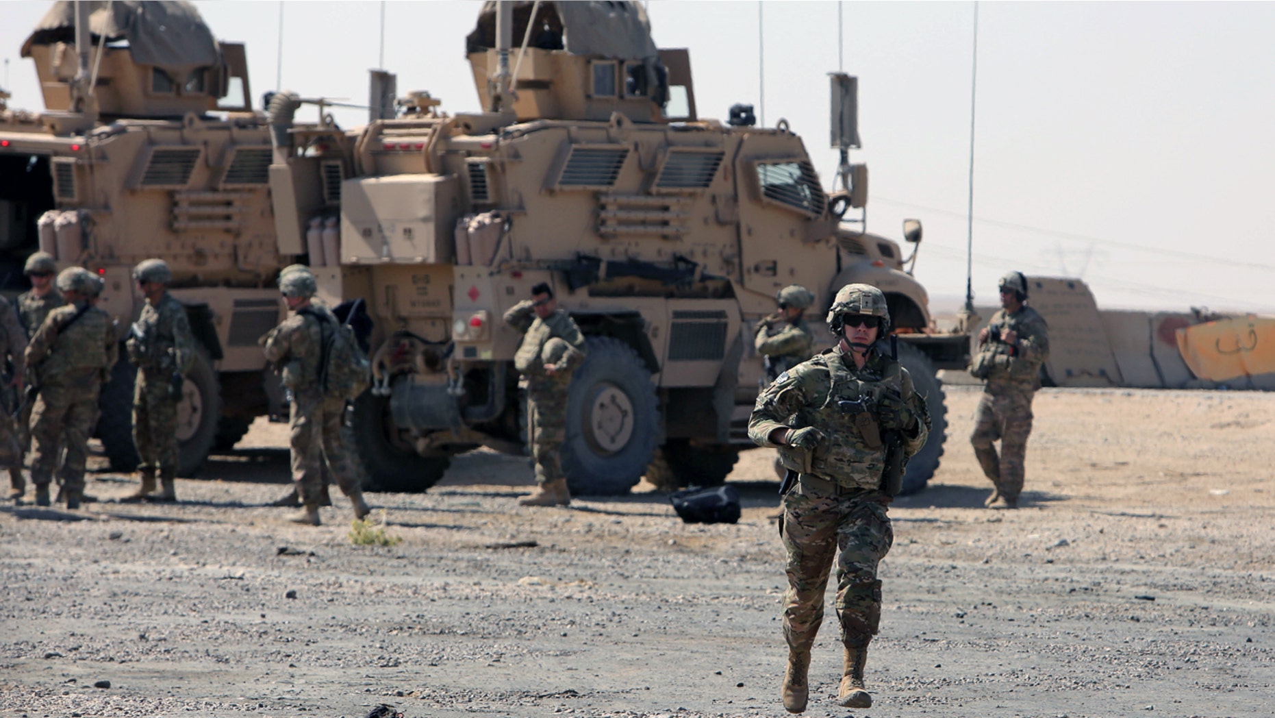 A U.S. soldier runs at a coalition forces forward base near West Mosul, Iraq this past June.