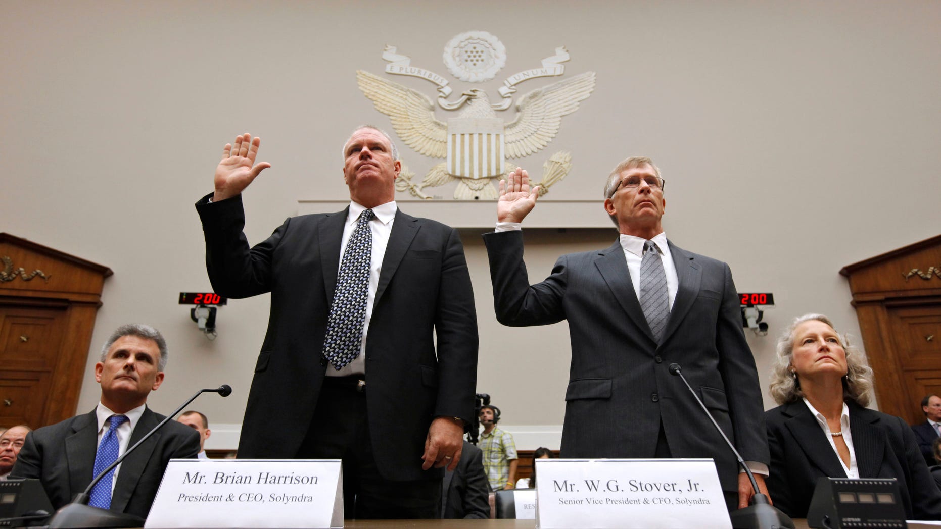 Solyndra CEO Brian Harrison. left, and Chief Financial Officer Bill Stover, right, are sworn in on Capitol Hill in Washington, Friday, Sept. 23 2011.