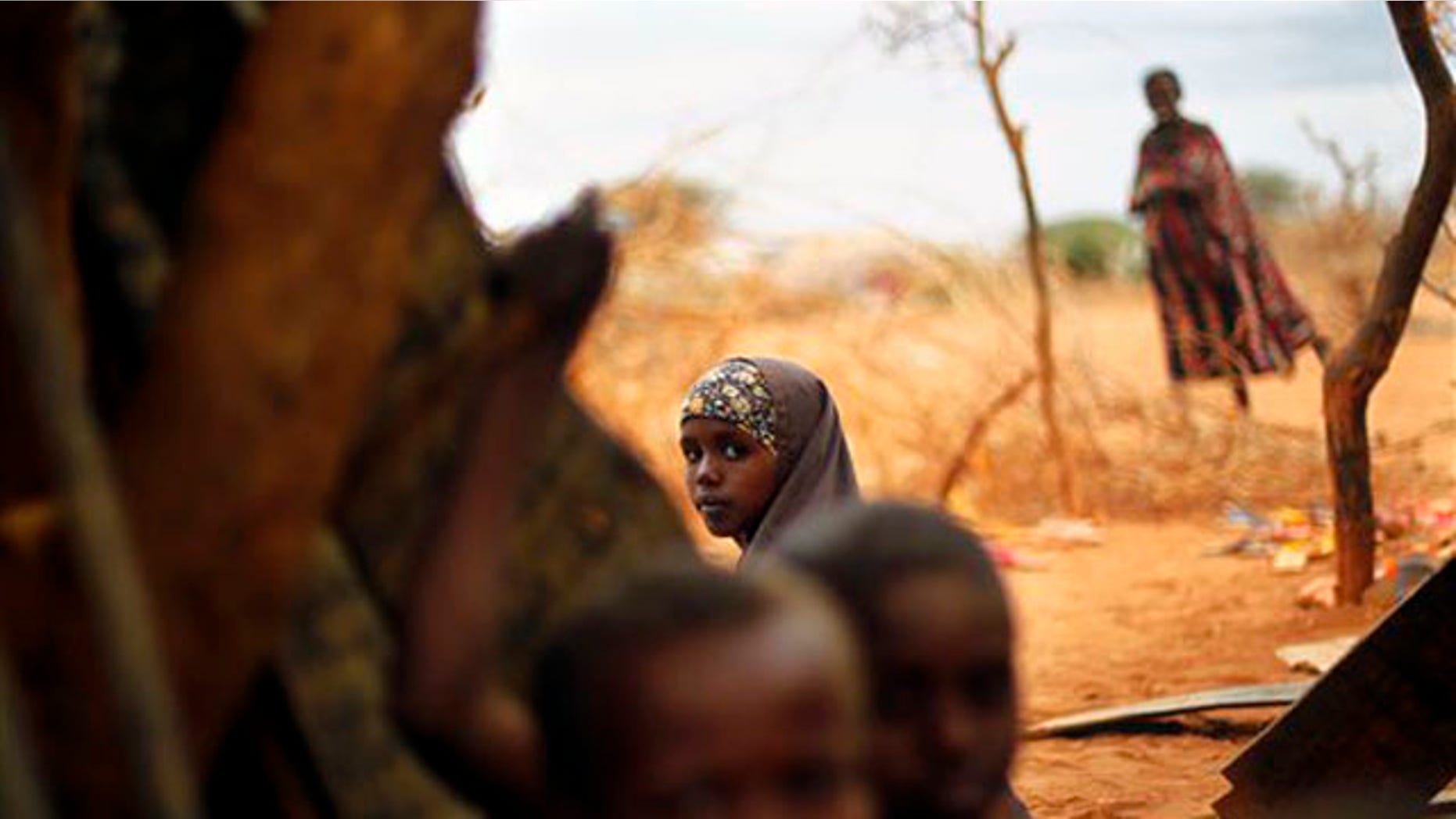Tuesday: A Somali refugee sits at an outdoor madrasa at the Ifo camp outside Dadaab, Eastern Kenya.