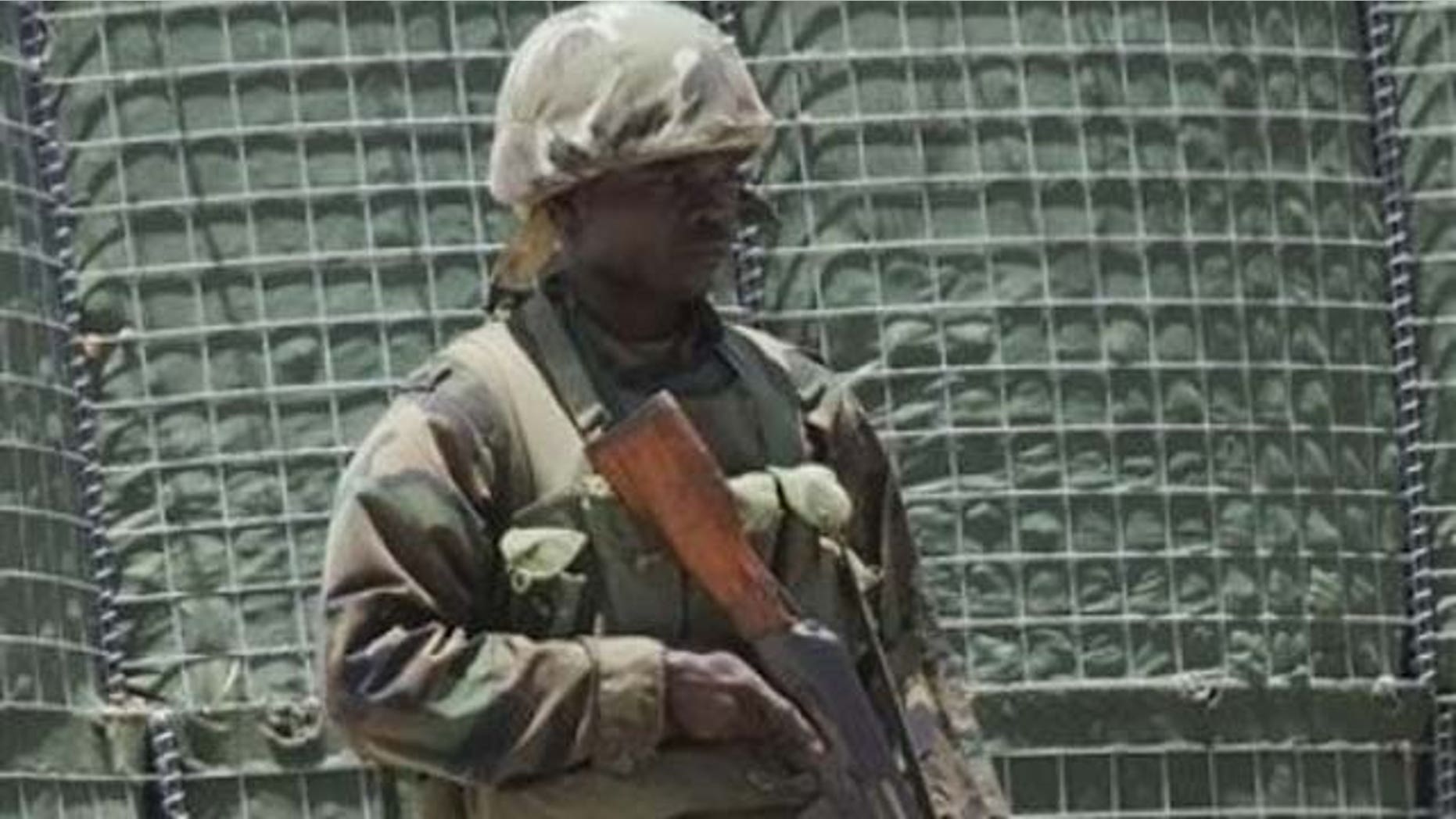 An African Union peacekeeper patrols on foot in Somalia.