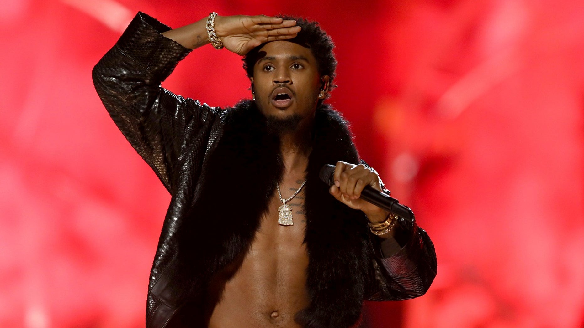 Singer Trey Songz, who is accused of felony domestic violence, turned himself in to Los Angeles police on Monday.