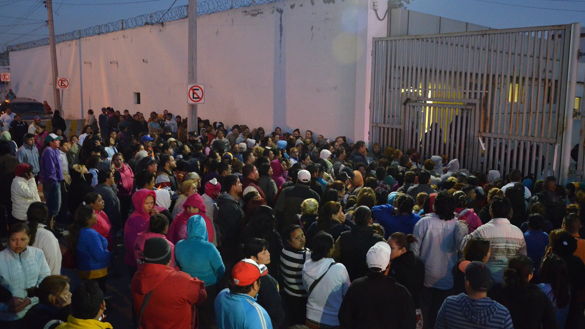 Feb. 11, 2016: Relatives of inmates stand outside the Topo Chico prison, where a riot broke out overnight in Monterrey, Mexico. (AP)
