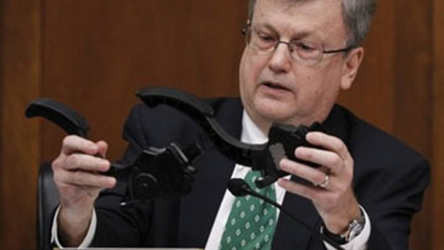 Feb. 24: House Oversight and Government Reform Committee member Rep. Mark Souder, R-Ind., holds two Toyota accelerator pedals while asking a question of Toyota President and Chief Executive Officer Akio Toyoda, on Capitol Hill in Washington. (AP Photo)