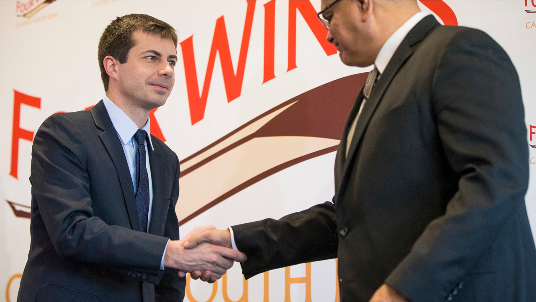 South Bend Mayor Pete Buttigieg, left, shakes hands with John Warren, chairman of the Pokagon Band, during news conference, Wednesday, Dec. 7, 2016, in South Bend, Ind.